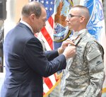 Secretary of Veterans Affairs Robert McDonald pins Army Staff
Sgt. Steven Tessitore with a Bronze Star and a Purple Heart during
a ceremony Dec. 19 at the Center for the Intrepid on Joint
Base San Antonio-Fort Sam Houston. Tessitore, an infantryman
with Company B, 2nd Battalion, 162nd Infantry Regiment, suffered
a gunshot wound Nov. 15, 2014, while on a quick reaction
force in Afghanistan.
Photo by Robert Shields
