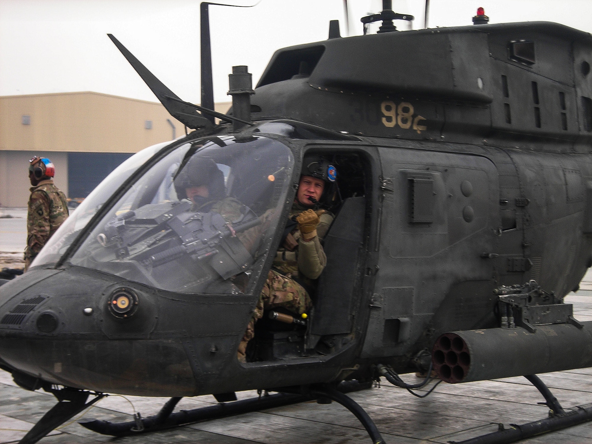 Master Sgt. Aaron Downing sits in a Bell OH-58 Kiowa helicopter in 2013 at Bagram Air Base, Afghanistan. Downing and his partner were conducting aerial reconnaissance of enemy crossing points. (Courtesy photo)