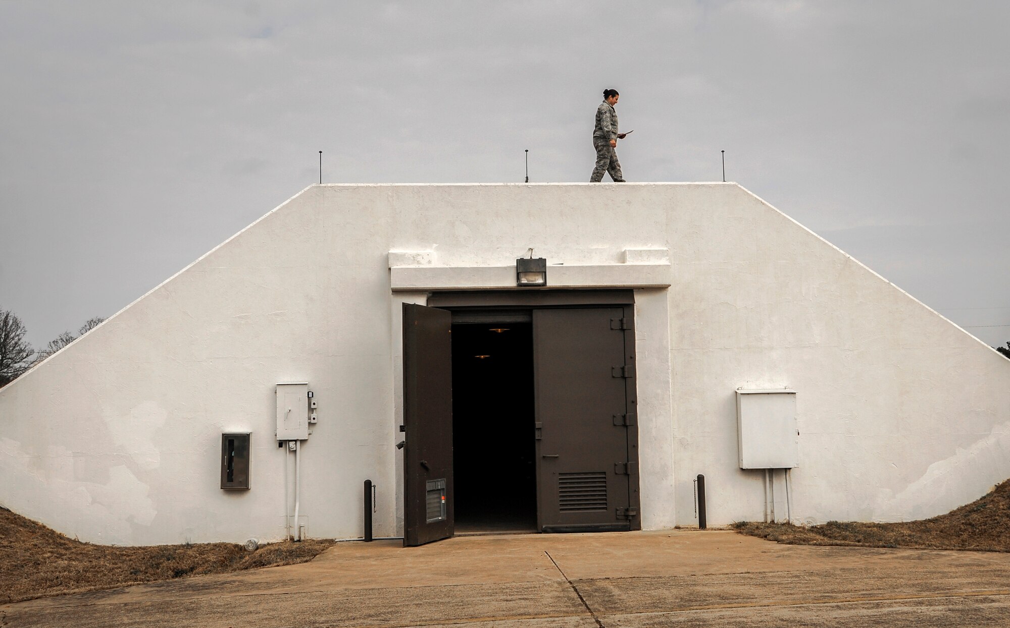 Senior Airman Micah Rodriguez, a 19th Maintenance Squadron munitions flight stockpile surveillance crewmember, performs a routine inspection on a bunker Dec. 11, 2014, at Little Rock Air Force Base, Ark. The 19th MXS munitions flight provides supplies to various Air Force and Army major commands. (U.S. Air Force photo by Airman 1st Class Harry Brexel)