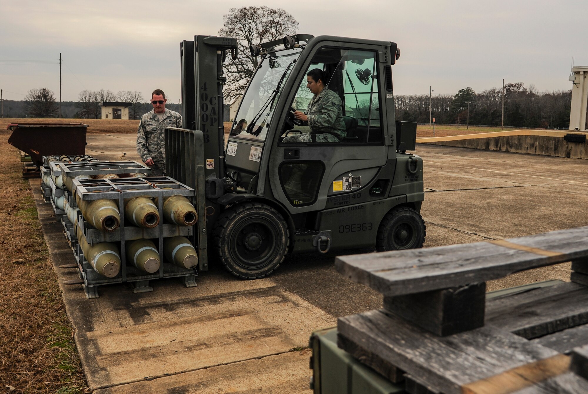 Staff Sgt. Alvin Reyes, a 19th Maintenance Squadron munitions flight stockpile surveillance crew chief, directs Senior Airman Micah Rodriguez, a 19th MXS munitions flight stockpile surveillance crewmember, to unload cargo Dec. 11, 2014, at Little Rock Air Force Base, Ark. The 19th MXS munitions flight supplies ammunitions, explosives and other propellants to Little Rock AFB and surrounding areas. (U.S. Air Force photo by Airman 1st Class Harry Brexel)