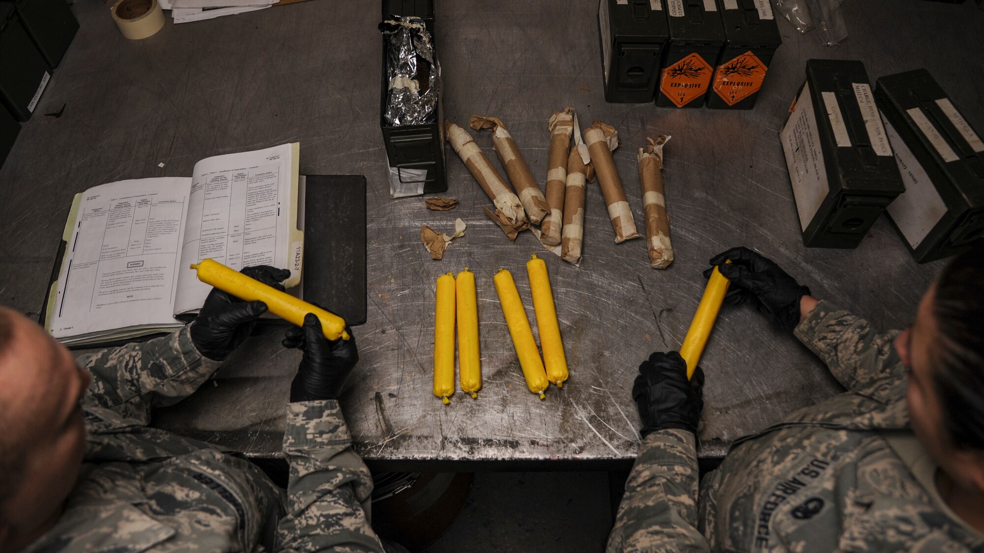Staff Sgt. Tavis Scheller, a 19th Maintenance Squadron munitions flight senior inspector, and Senior Airman Micah Rodriguez, a 19th MXS munitions flight stockpile surveillance crewmember, ensure packages filled with ammonium nitrate are not damaged Dec. 11, 2014, at Little Rock Air Force Base, Ark.  The ammonium nitrate is used along with other explosives to train military working dogs in detecting chemical hazards. (U.S. Air Force photo by Airman 1st Class Harry Brexel)