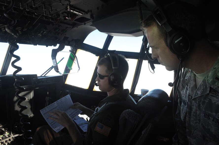 U.S. Air Force Capt. Tyrel Lyon, 317th Operation Support Squadron pilot, explains a chart to 2nd Lt. Jeffrey Hartshorn, 7th Force Support Squadron military personnel section chief, during a new Impact Day Program Dec. 12, 2014, at Dyess Air Force Base, Texas. The program allows Airmen in supporting roles such as the 7th Medical Group and 7th Mission Support Group an inside look at the operations of the 317th Airlift Group. (U.S. Air Force photo by Airman 1st Class Autumn Velez/Released)