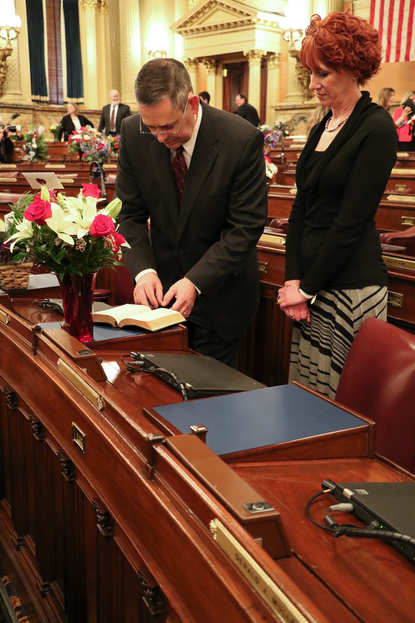 Pennsylvania State Representative Cris Dush, left, master sergeant with the 193rd Special Operations Security Forces Squadron and wife Traci Dush page through his Bible prior to the Pennsylvania House of Representative Swearing-In Ceremony, Harrisburg, Jan. 6, 2015. Dush will represent approximately 62,000 people in the 66th Legislative District. (U.S. Air National Guard photo by Tech. Sgt. Culeen Shaffer/Released)