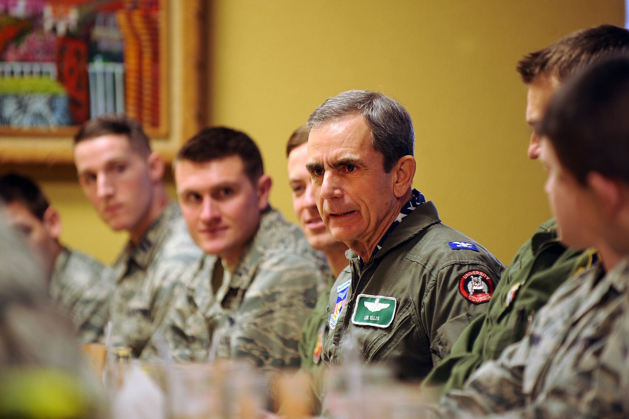 Retired U.S. Air Force Col. Leon "Lee" Ellis, a fighter pilot and former prisoner of the Vietnam War, meets with sixteen company grade officers from Offutt Air Force Base during an off-base luncheon held in Bellevue, Neb. Jan. 5, 2015.  Ellis visited with hundreds of Offutt personnel during his visit  where he provided lessons in leadership and resiliency.  (U.S. Air Force photo by Josh Plueger/Released)
