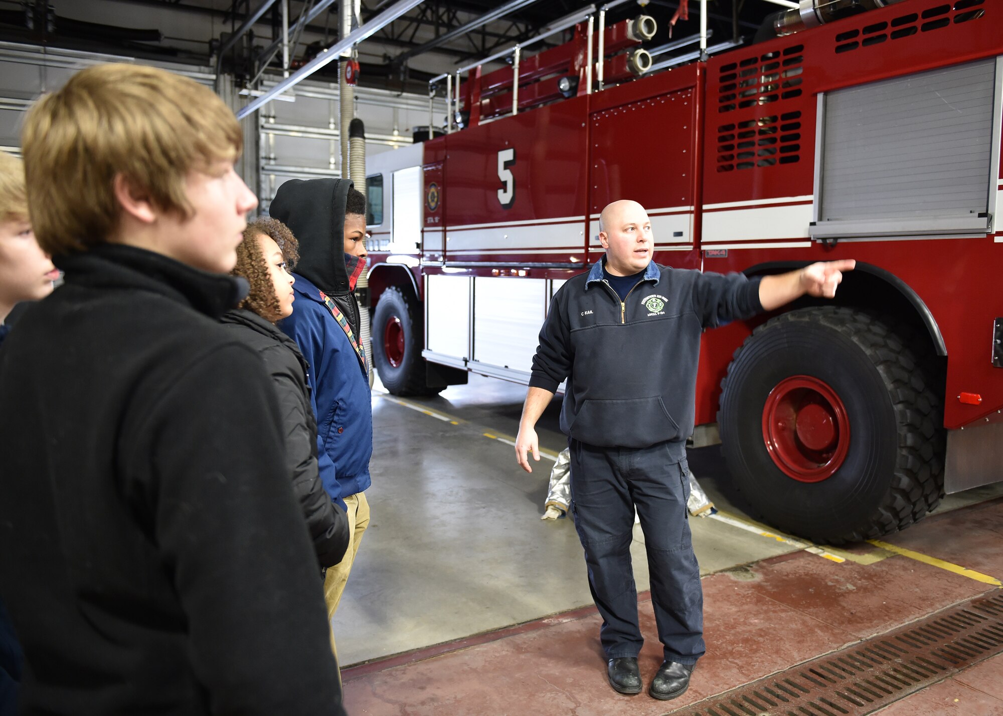 Chris Kail, a firefighter with the 910th Civil Engineer Fire Department, discusses his job with students from Cuyahoga Valley Christian Academy here, Jan. 7, 2015. Approximately 12 students from the school came to Youngstown Air Reserve Station for an educational visit as part of their career week emphasizing military and service careers. U.S. Air Force photo/Eric M. White.