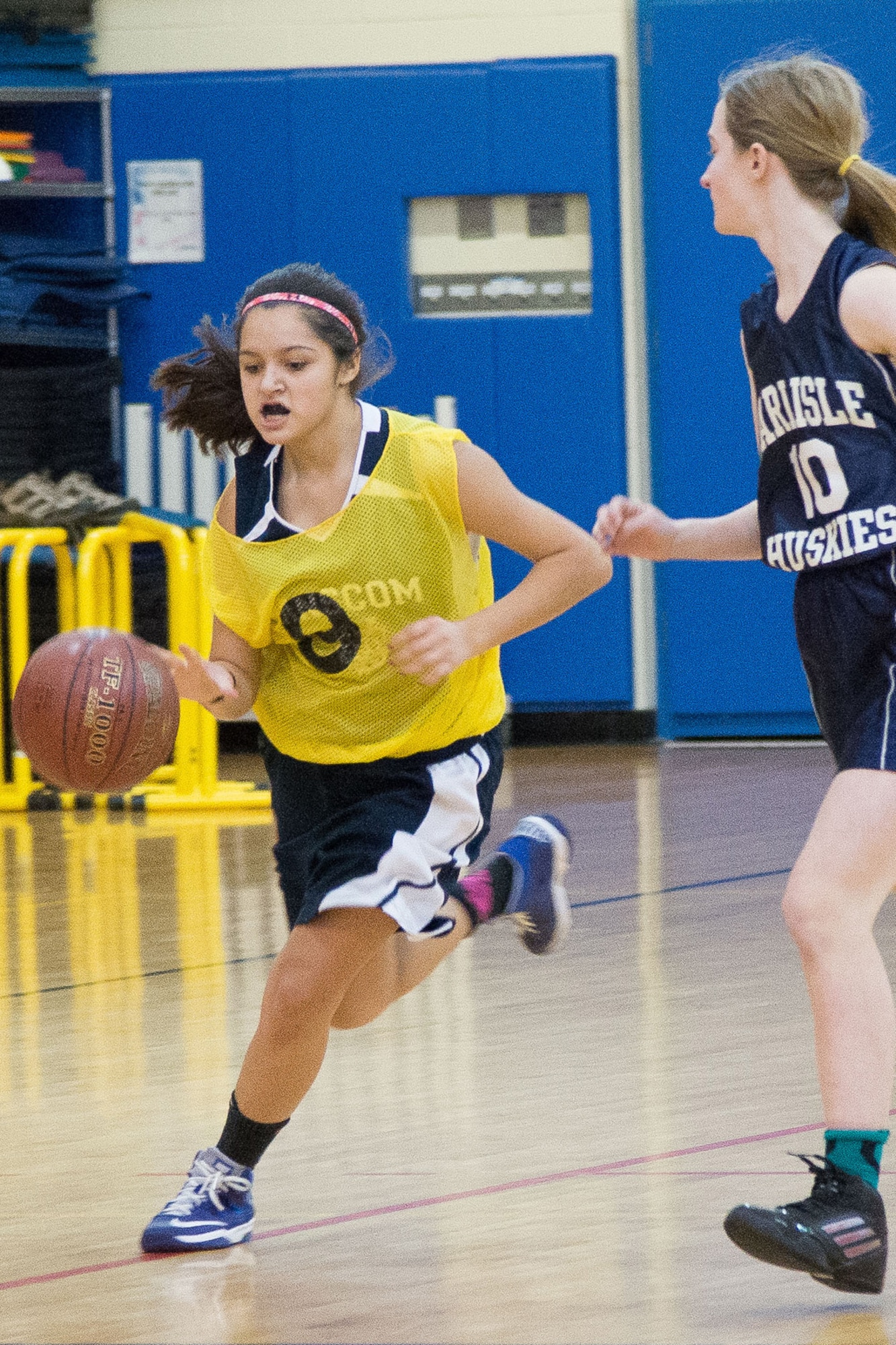 Eighth Grader Alexandra Munoz, a Hanscom Middle School Falcons girls' basketball player, drives past a Carlisle Middle School defender during a middle school game at the Hanscom Fitness and Sports Center, Jan. 6. The Falcons lost to Carlisle Middle School 34 to 14. (U.S. Air Force photo by Mark Herlihy)