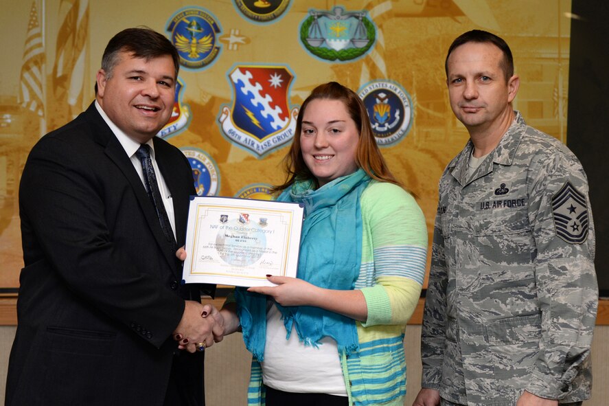 Thomas E. Fredericks, 66th Air Base Group deputy director, and Hanscom Air Force Base Command Chief Master Sgt. Craig Poling, pose for a photo with NAF of the Quarter Category 1 Nominee Meghan Flaherty, 66th Force Support Squadron assistant aquatics manager, during the group’s fourth quarter awards ceremony at the Hanscom Conference Center, Jan. 7. The ceremony recognizes the performance of military and civilian members of the 66th Air Base Group for performance throughout the last quarter. (U.S. Air Force photo by Linda LaBonte Britt)