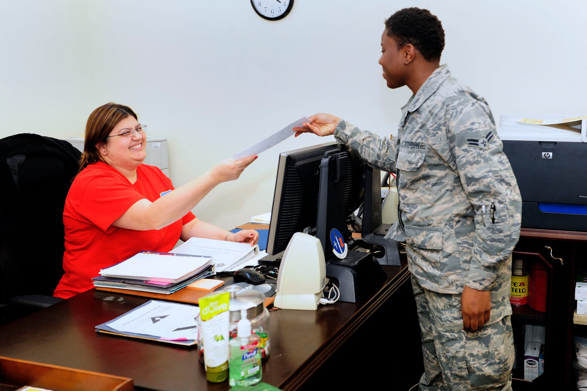 Cheryl Jackson, 39th Comptroller Squadron administrative assistant, discusses paperwork with Airman 1st Class Lasondra Copeland, 39th CPTS administrative support, Dec. 16, 2014, Incirlik Air Base, Turkey. Jackson won the Financial Management Civilian of the Year, Category I award in the U.S. Air Forces in Europe - Air Forces Africa Financial Management annual awards. (U.S. Air Force photo by Senior Airman Krystal Ardrey/Released)