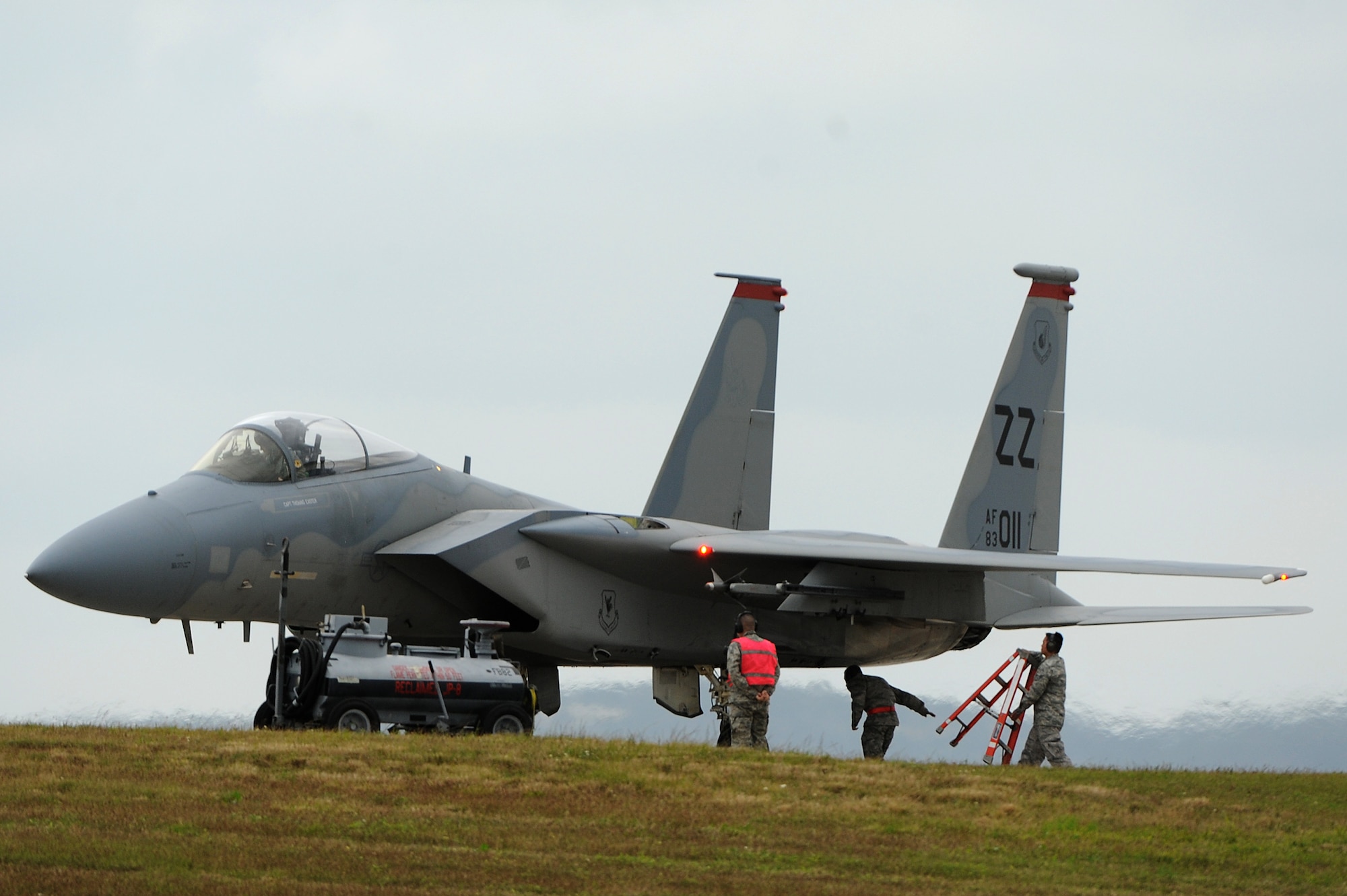 U.S. Air Force Airmen from the 67th Aircraft Maintenance Unit service a 67th Fighter Squadron F-15C Eagle during a training surge on Kadena Air Base, Japan, Jan. 7, 2015. Surges increase the number of training flights each day during a set time period in order to increase power proficiency and ensure combat readiness. Each surge focuses on a different aspect of combat readiness. This training is designed to focus on basic fighter maneuvers. (U.S. Air Force photo by Airman 1st Class Zade C. Vadnais) 
