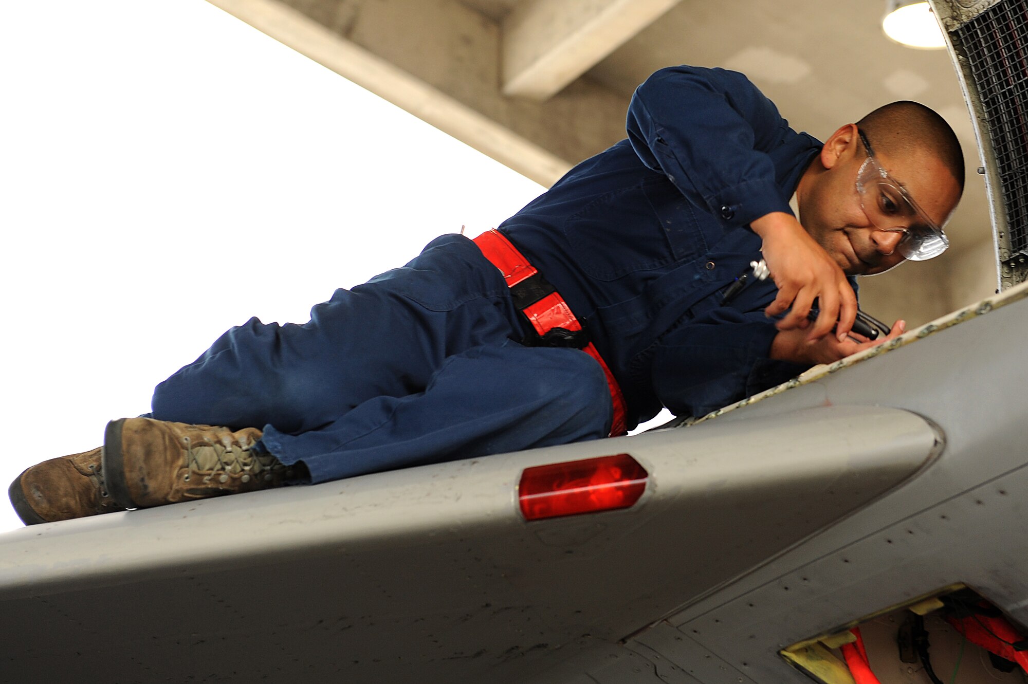 U.S. Air Force Senior Airman Casey Dominguez, 67th Aircraft Maintenance Unit weapons flight load crew member, prepares an F-15C Eagle to participate in a training surge on Kadena Air Base, Japan, Jan. 8, 2015. The purpose of a training surge is to increase the number of flying hours each day during a set period of time with the goal of increasing power proficiency and ensuring combat readiness. (U.S. Air Force photo by Airman 1st Class Zade C. Vadnais)