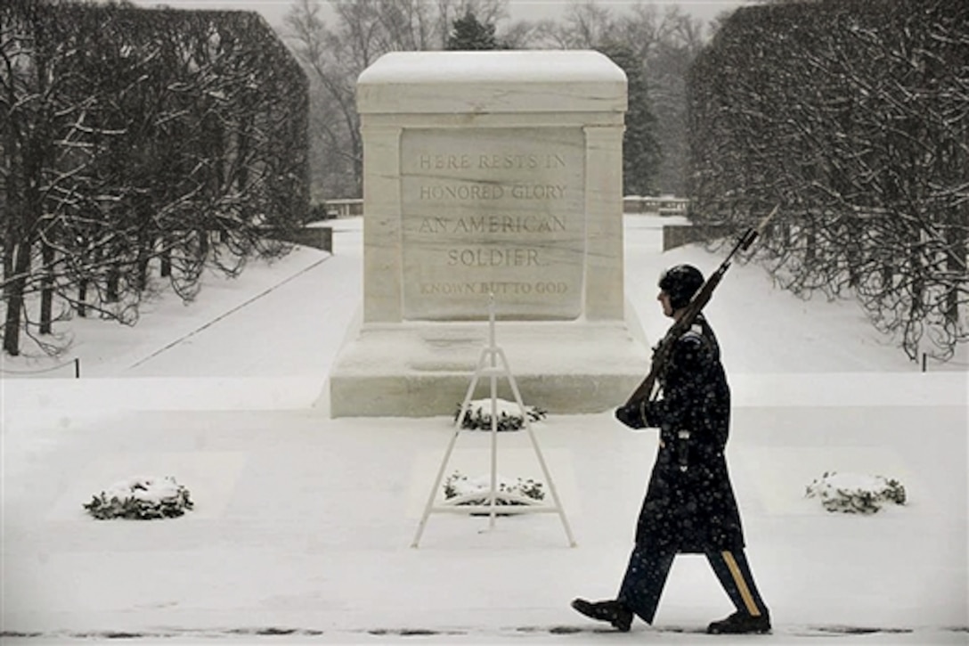 A tomb sentinel guards the Tomb of the Unknown Soldier during the first snow of the year in Arlington National Cemetery in Arlington, Va., Jan. 6, 2015. The soldier is assigned to 3rd U.S. Infantry Regiment, known as "The Old Guard."  