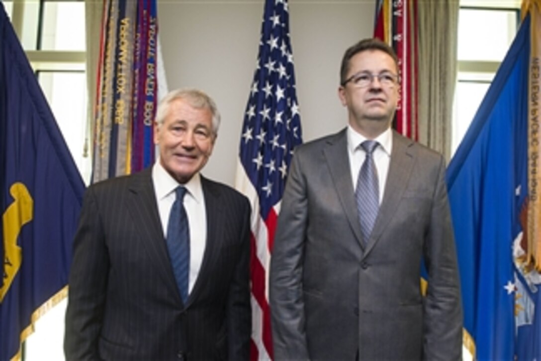 U.S. Defense Secretary Chuck Hagel poses for a photo with Slovak Defense Minister Martin Glvac at the Pentagon Jan. 8, 2015. Hagel hosted an honor cordon for Glvac and the two leaders met to discuss issues of mutual concern.