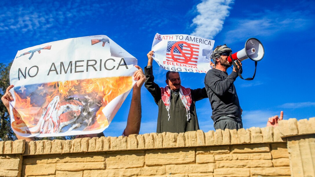 Arabic-speaking role-players simulate a riot outside the gates of a combat simulation town aboard Camp Pendleton, Calif., Jan. 7, 2015. The role-players dressed for the part and spoke the language to create a cultural and language barrier for Marines of 3rd Battalion, 7th Marine Regiment, 1st Marine Division during a training exercise.