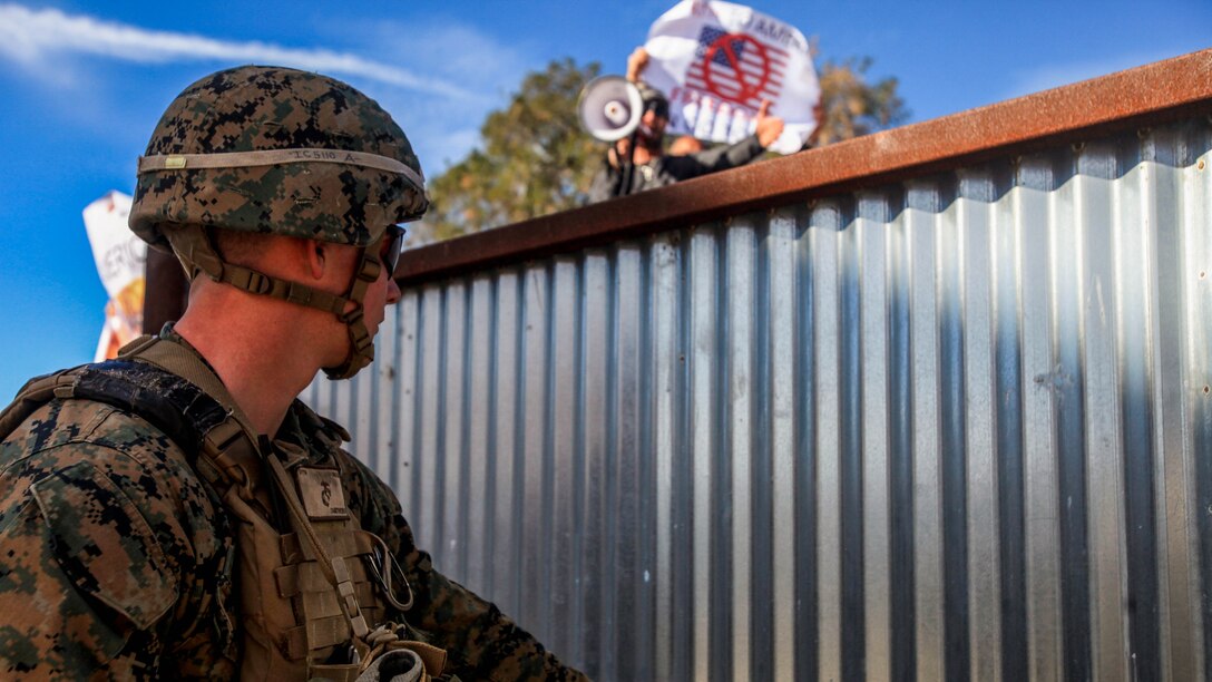 Corporal Benny Carithers, a squad leader with Company I, 3rd Battalion, 7th Marine Regiment, 1st Marine Division, provides security for a combat simulation town during an exercise aboard Camp Pendleton, Calif., Jan. 7, 2015. The training focused on efficient crisis response without the use of lethal force. 
