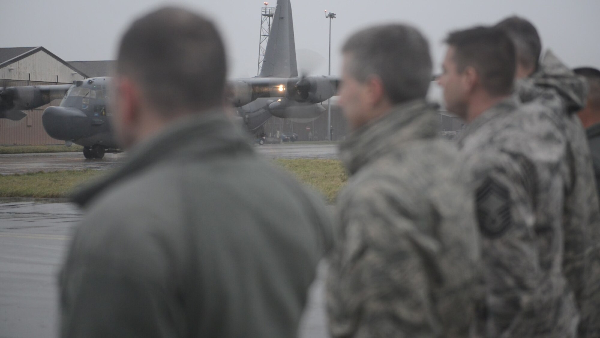 Airmen from the 352nd Special Operations Group and the 100th Air Refueling Wing line Delta Row taxiway Jan. 8, 2015, render a final salute as the MC-130H Combat Talon II departs RAF Mildenhall for Hurlburt Field, Florida. This departure flight concludes its tenure at the 7th Special Operations Squadron at RAF Mildenhall. The MC-130H, tail number 0195, is the last of its kind to leave the European theater. (U.S. Air Force photo by Senior Airman Laura Yahemiak/Released)