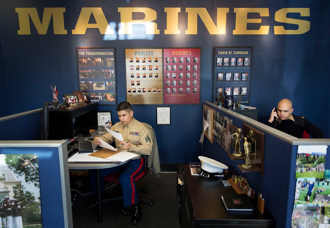 LYNWOOD, Wa.-- Sgt. Ricardo Schebesta (left) and Staff Sgt. Bryson Twigg, Marine recruiters in Lynnwood and Everett, Washington, process paperwork and call potential applicants in their Lynnwood recruiting office Jan. 7, 2015. After hearing shouting and honking outside their office Jan. 6, Schebesta, Twigg and Staff Sgt. Ben Shoemaker responded to a situation in which two young men attempted to rob an elderly woman. Despite being told by the victim the suspects were armed with a gun, the Marines ran through rush-hour traffic to pursue them. Shoemaker subdued one of the suspects using a wrist lock, a technique taught in the Marine Corps Martial Arts Program, and held the suspect until police arrived to arrest him. Police retrieved a metal bat from the suspect’s pants but have not yet located his accomplice. Schebesta is from Anaheim, California. Shoemaker is from Spokane, Washington. Twigg is from Akron, Ohio. (U.S. Marine Corps photo by Sgt. Reece Lodder)