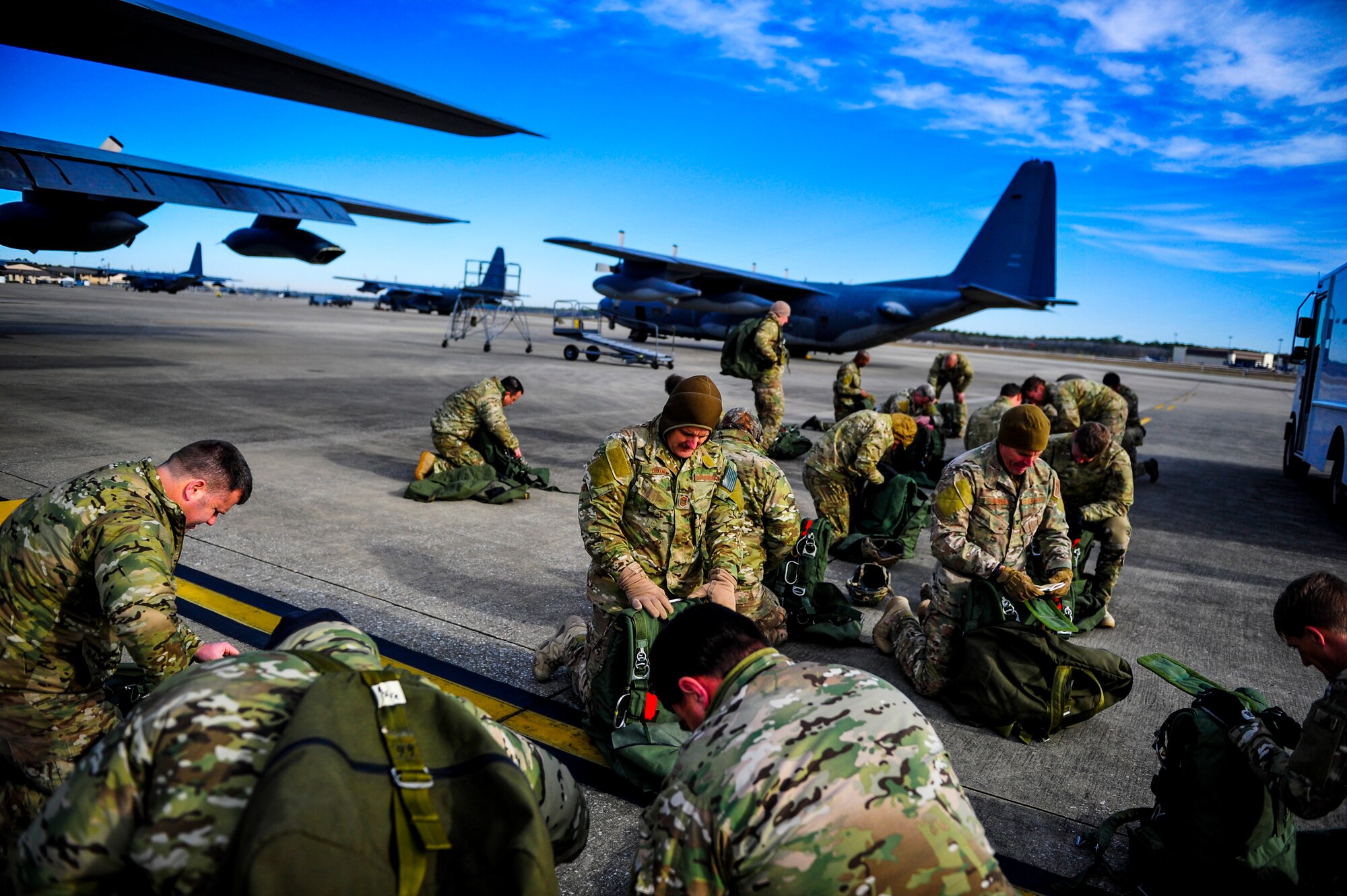 Members from the 24th Special Operations Wing prepare for a high-altitude low-opening jump from an MC-130H Talon II at Hurlburt Field, Fla., Jan. 7, 2014. A total of 16 members used the jump to maintain qualification. Special Tactics Airmen, such as combat controllers and pararescuemen, train to jump into hostile or austere environments not accessible to aircraft.   (U.S. Air Force photo/Senior Airman Christopher Callaway) 