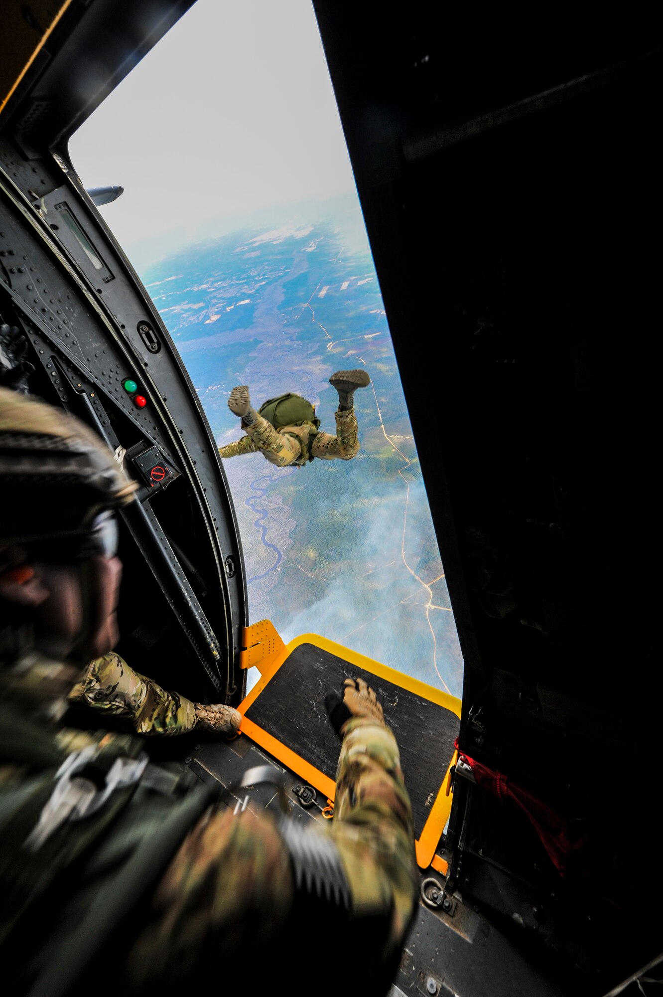 Special Tactics Airmen from the 24th Special Operations Wing jump out the door of an MC-130H Talon II at Hurlburt Field, Fla., Jan. 7, 2014. A group of 16 jumpers trained for real-world jumps into austere or hostile environments, when aircraft aren’t able to land in enemy territory or rough terrain.  (U.S. Air Force photo/Senior Airman Christopher Callaway) 