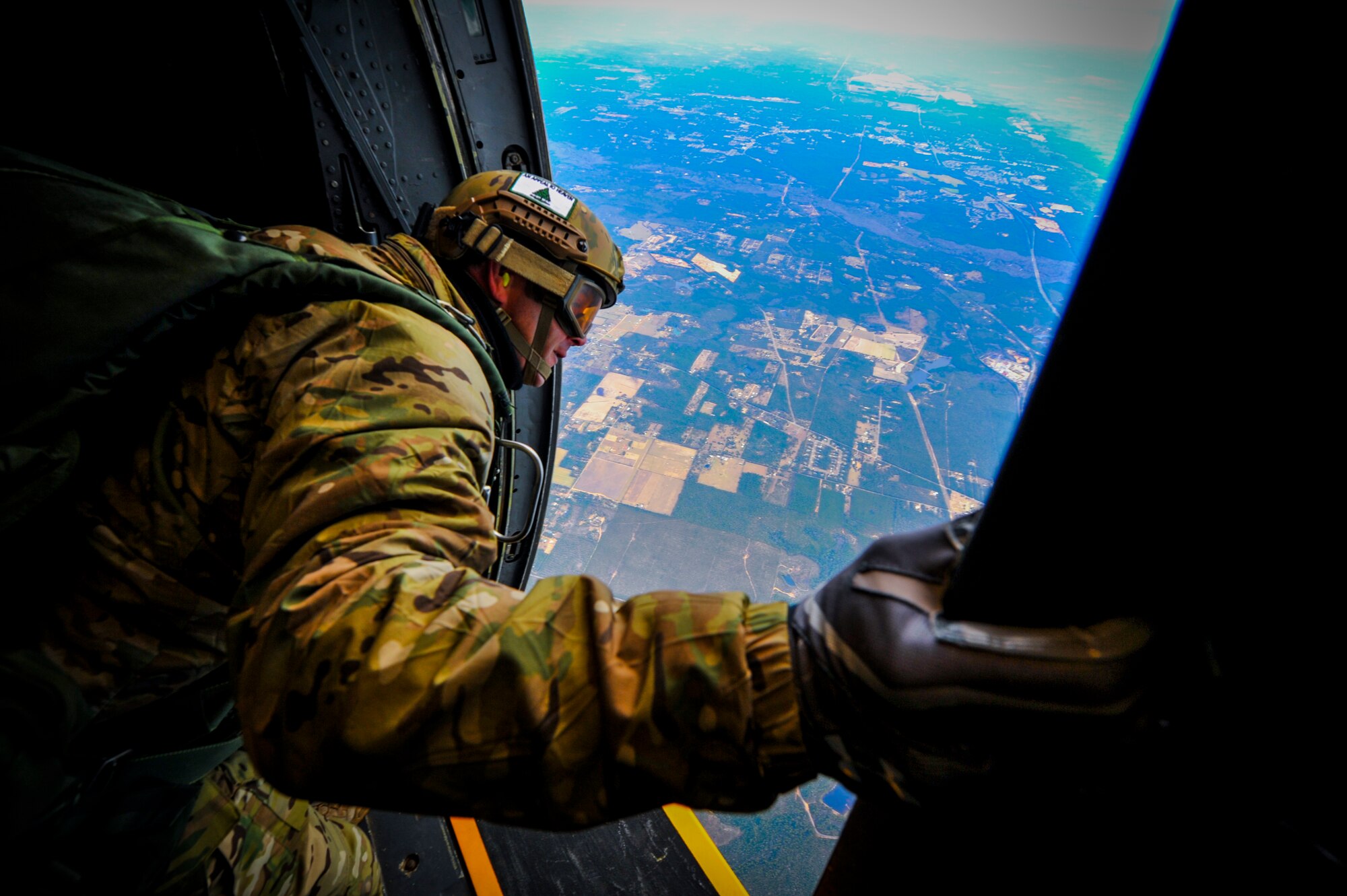 A Special Tactics Airman from the 24th Special Operations Wing scans the drop zone before jumping out of an MC-130H Talon II at Hurlburt Field, Fla., Jan. 7, 2014. A total of 16 members used the jump to maintain qualification. Special Tactics Airmen, such as combat controllers and pararescuemen, train to jump into hostile or austere environments not accessible to aircraft.   (U.S. Air Force photo/Senior Airman Christopher Callaway) 