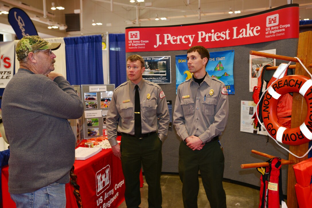 U.S. Army Corps of Engineers Nashville District Park Ranger Charlie Leath from the Old Hickory Lake (left) and Park Ranger Noel Smith from J. Percy Priest Lake (right) talk with Nathan Singer from Nashville about water safety and fishing near the Cheatham Dam at the 29th annual Nashville Boat & Sportshow on Thursday, Jan. 8, 2015 in Music City Center.    