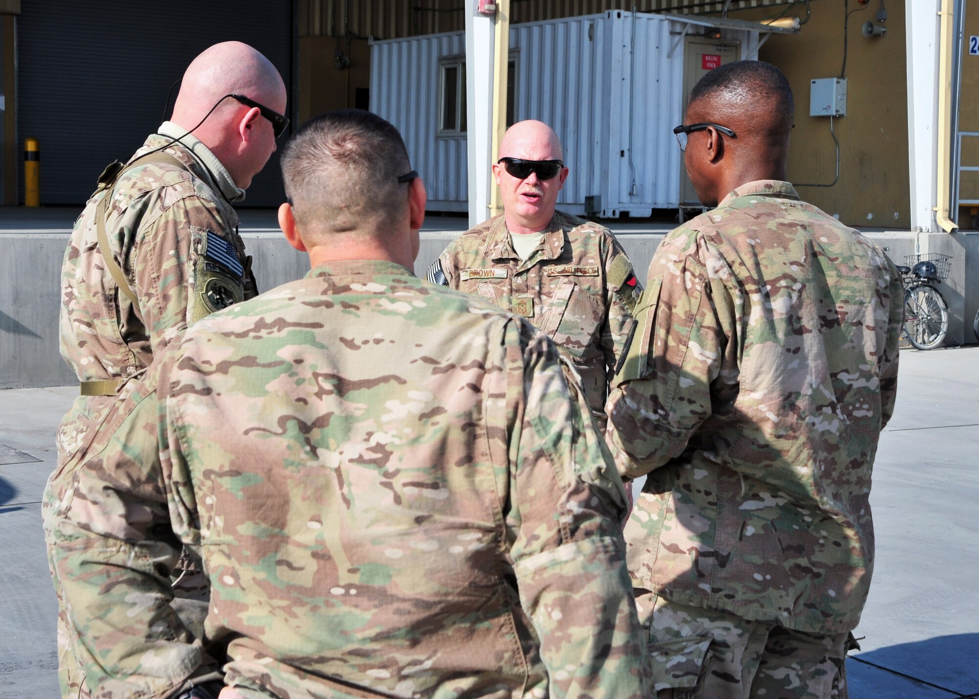 U.S. Air Force Chief Master Sgt. Jeffrey Brown, 455th Air Expeditionary Wing command chief, U.S. Air Force Chief Master Sgt. Jamie Vanoss, 455th Expeditionary Logistics Readiness Squadron aerial port flight, U.S. Army Command Sgt. Maj. Christopher Gilpin, Combined Joint Task Force 3 United States Forces Afghanistan, and U.S. Army Sgt. Maj. John Woodson, Combined Joint Task Force 3 United States Forces Afghanistan joint staff operations, talk during a tour Jan. 6, 2015 at Bagram Airfield, Afghanistan. During the tour, Gilpin and Woodson had the opportunity to meet with 455th Air Expeditionary Wing leadership and become better acquainted with Air Force assets and squadrons. (U.S. Air Force photo by Staff Sgt. Whitney Amstutz/released)