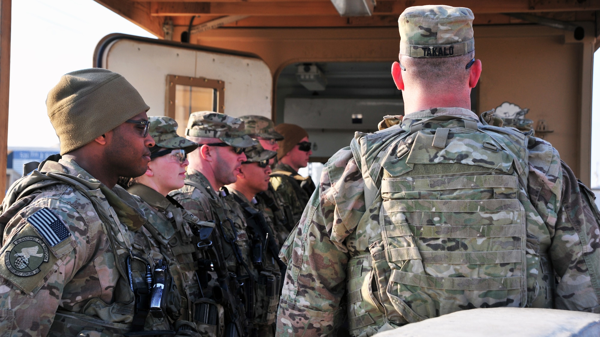 U.S. Air Force Airmen and U.S. Army soldiers prepare to meet U.S. Army Command Sgt. Maj. Christopher Gilpin, Combined Joint Task Force 3 United States Forces Afghanistan, during a tour Jan. 6, 2015 at Bagram Airfield, Afghanistan. During the tour, Gilpin had the opportunity to meet with 455th Air Expeditionary Wing leadership and become better acquainted with Air Force assets and squadrons. (U.S. Air Force photo by Staff Sgt. Whitney Amstutz/released)
