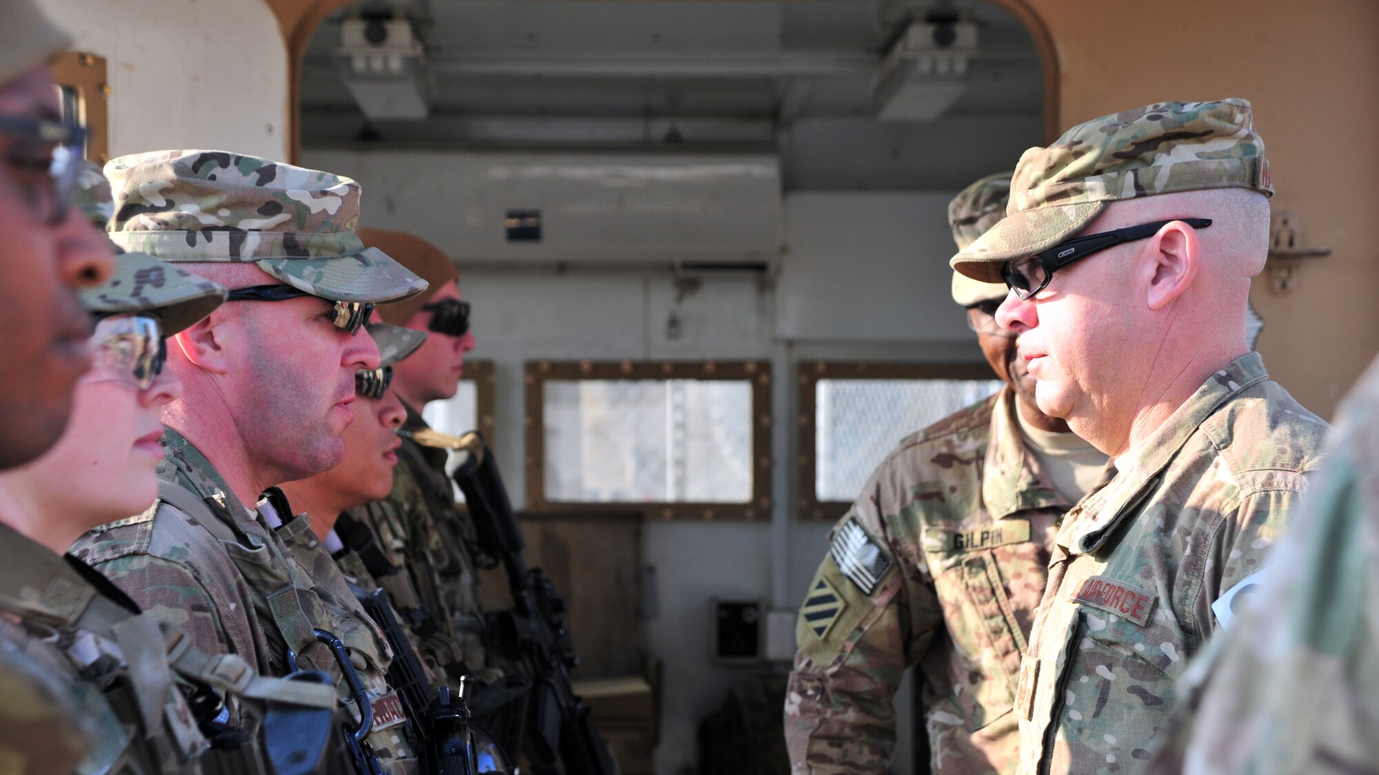 U.S. Air Force Chief Master Sgt. Mark Hammack, 455th Expeditionary Security Forces Squadron, and U.S. Army Command Sgt. Maj. Christopher Gilpin, Combined Joint Task Force 3 United States Forces Afghanistan, meet with defenders during a tour Jan. 6, 2015 at Bagram Airfield, Afghanistan. During the tour, Gilpin had the opportunity to meet with 455th Air Expeditionary Wing leadership and become better acquainted with Air Force assets and squadrons. (U.S. Air Force photo by Staff Sgt. Whitney Amstutz/released)