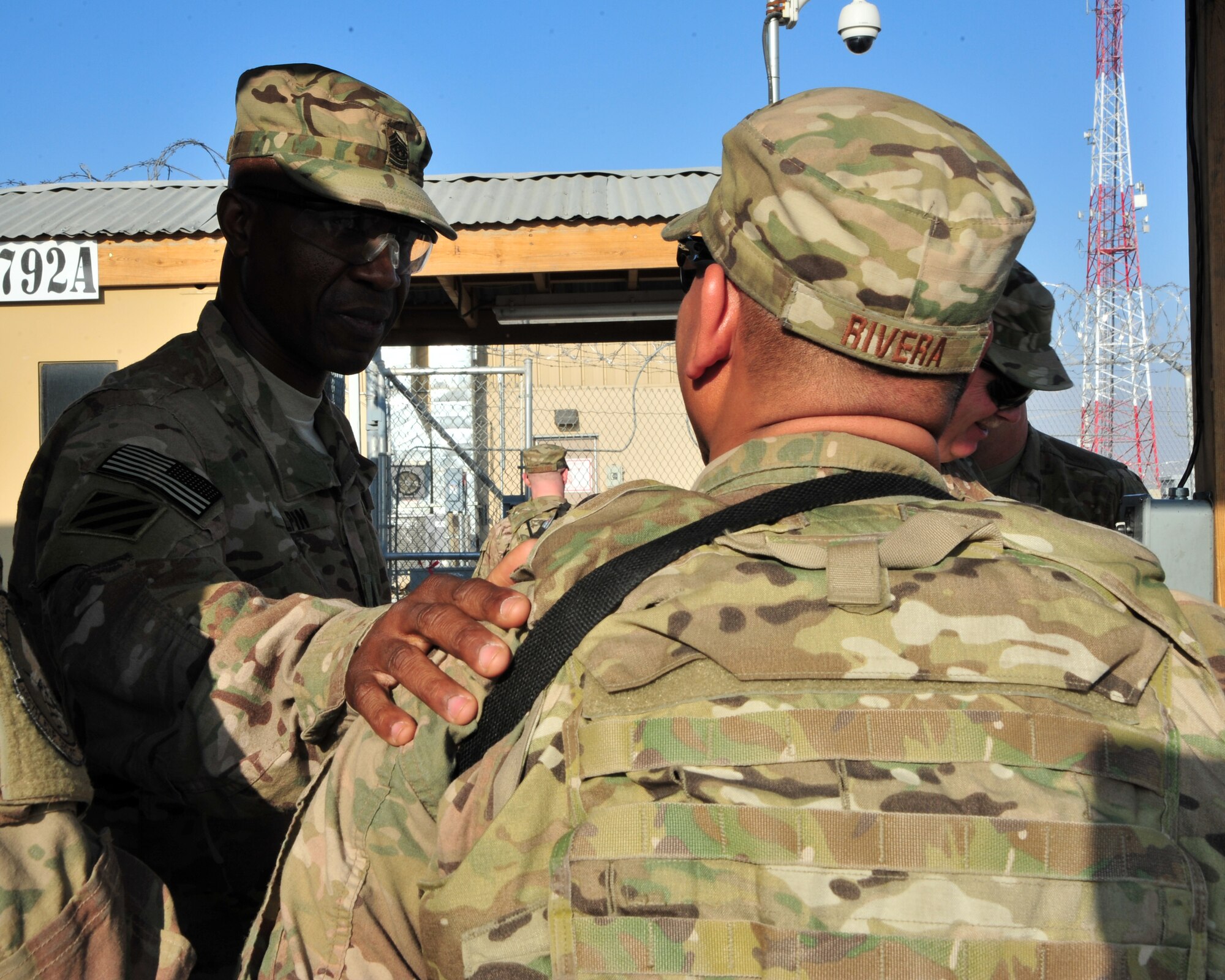 U.S. Army Command Sgt. Maj. Christopher Gilpin, Combined Joint Task Force 3 United States Forces Afghanistan, speaks with Tech. Sgt. David Rivera, 455th Expeditionary Security Forces Squadron defender, during a tour Jan. 6, 2015 at Bagram Airfield, Afghanistan. During the tour, Gilpin had the opportunity to meet with 455th Air Expeditionary Wing leadership and become better acquainted with Air Force assets and squadrons. (U.S. Air Force photo by Staff Sgt. Whitney Amstutz/released)