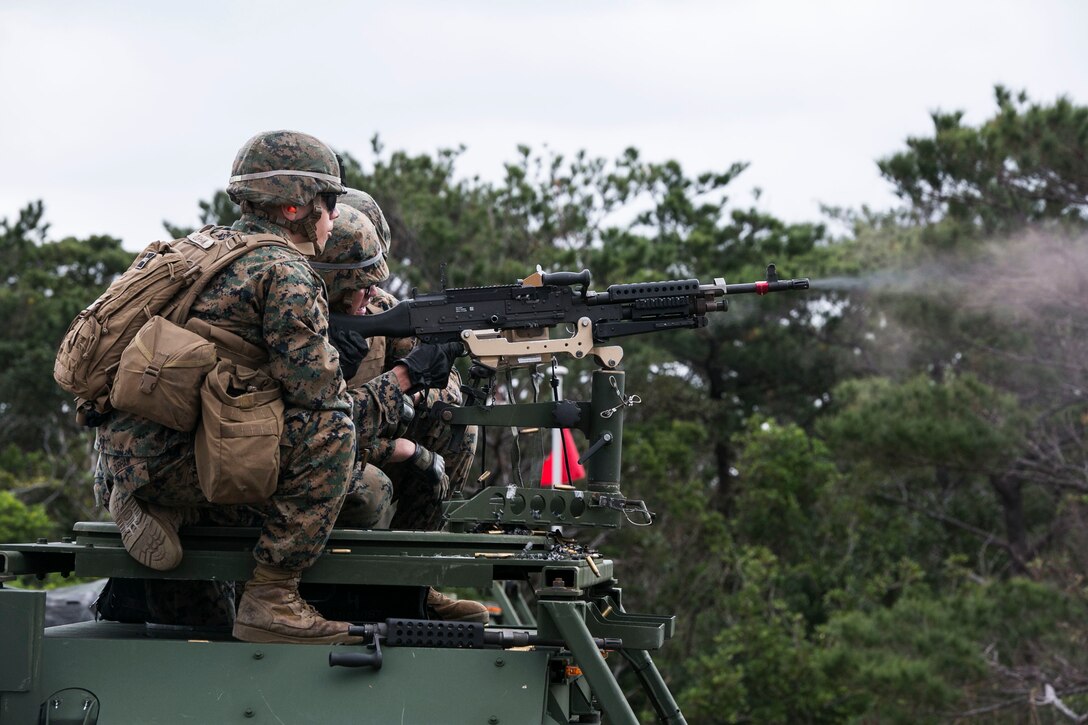 Lance Cpl. Felix C. Jovel, right, fires an M240B medium machine gun from a 7-ton truck as Cpl. Anthony Durham, left, observes during training Jan. 7 at Range 9 in the Central Training Area. The Marines engaged static targets from distances up to 1,000 feet, increasing confidence in their accuracy with the weapon system. Jovel, from Frederick, Maryland, and Durham, from Kemp, Texas, are motor vehicle operators with Truck Company, Headquarters Battalion, 3rd Marine Division, III Marine Expeditionary Force.
