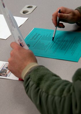 An attendee of the Troops to Teachers seminar reviews informational packets provided Jan. 6, 2014, in the education center, F.E. Warren Air Force Base, Wyo. The seminar informs service members, prior service and retirees of the opportunities Troops to Teachers provides to assist in the transition to the education career field. (U.S. Air Force photo/Airman 1st Class Malcolm Mayfield)