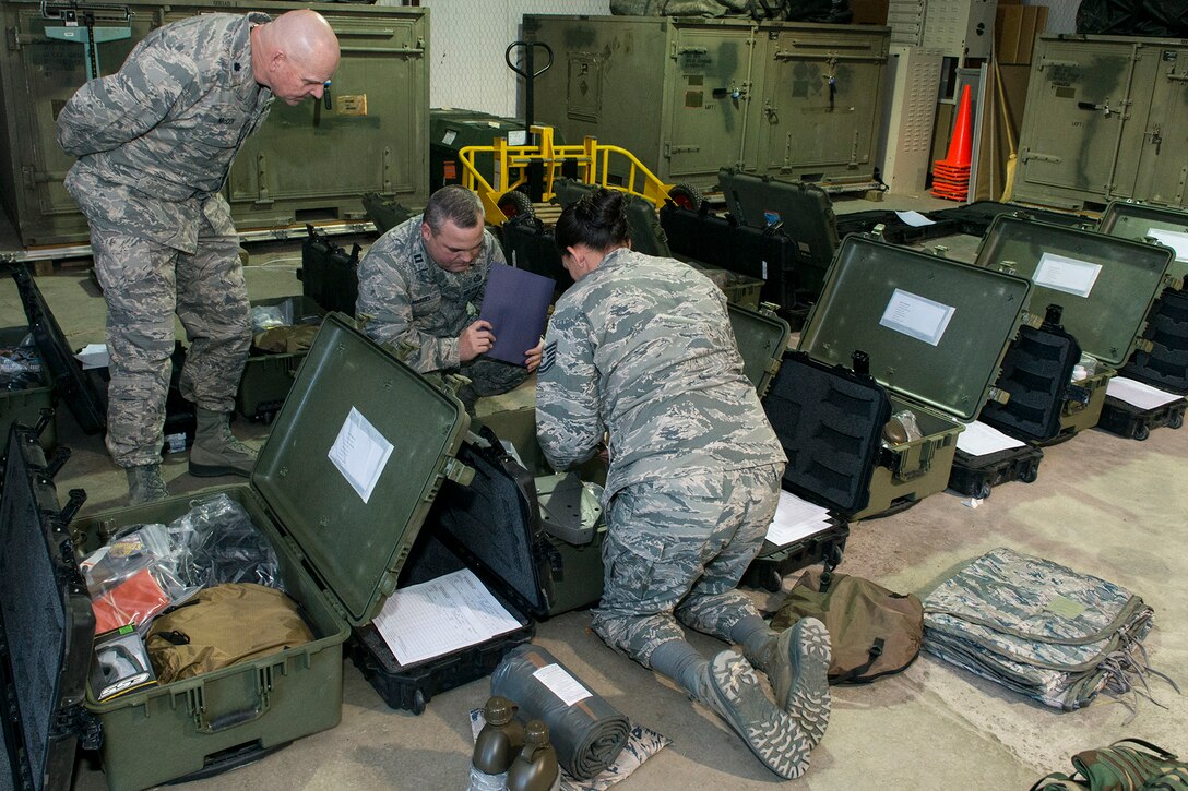 U.S. Air Force Lt. Col. Charles McCoy, Capt. Jerry Hardel and Tech. Sgt. Starlight Lesher perform an inventory inspection of mobility equipment required for the 307th Security Forces Squadron, Jan. 6, 2015, Barksdale Air Force Base, La. The inspection was in preparation for a mobility exercise the 307th Bomb Wing will undergo during the January Unit Training Assembly. (U.S. Air Force photo by Master Sgt. Greg Steele/Released)