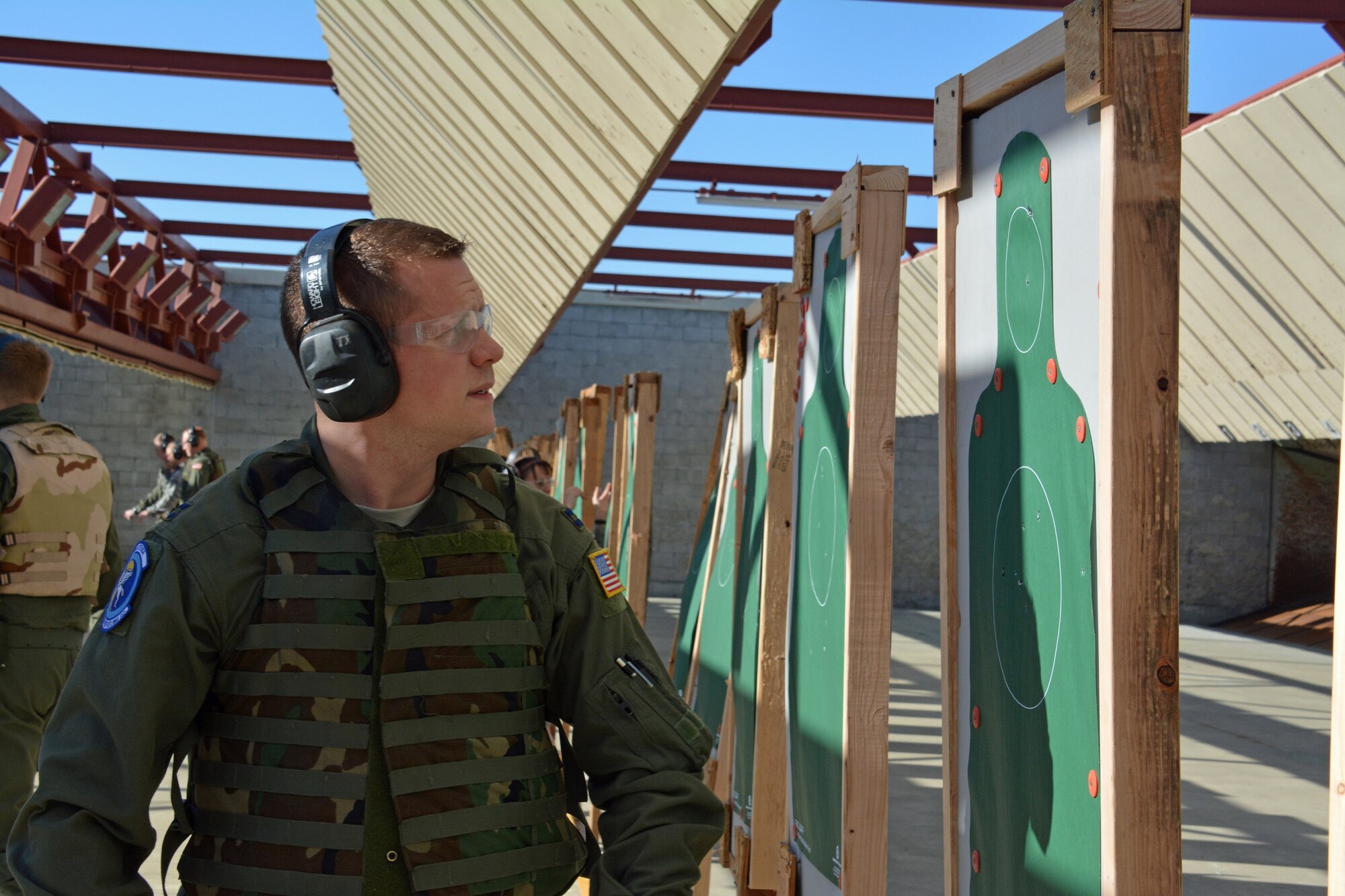 An Air Force captain looks at his target Jan. 6, 2015, at the Combat Arms firing range on Travis Air Force Base, California. The captain was part of a group of more than 20 students who trained on the M-9 pistol, a semiautomatic weapon. (U.S. Air Force photo by Nick DeCicco)