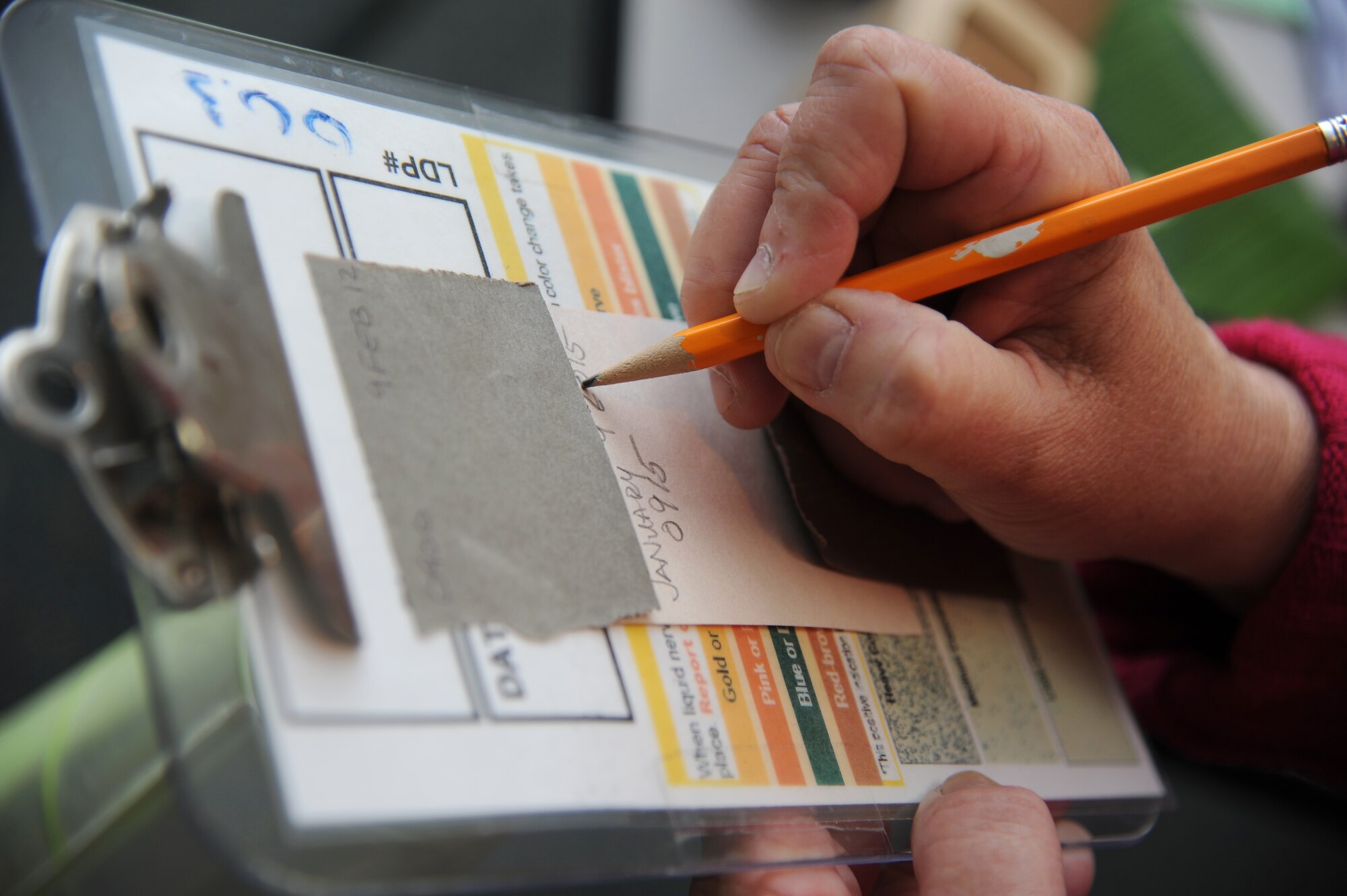 Roseanne Peterson, Base Operations Support emergency manager, logs information on an M-8 chemical agent detection paper prior to the start of the chemical, biological, radiological and nuclear class Jan. 9, 2015, at the civil engineering compound, Keesler Air Force Base, Miss.  Peterson was recently awarded the Defense Department certification in the emergency management field. (U.S. Air Force photo by Kemberly Groue)