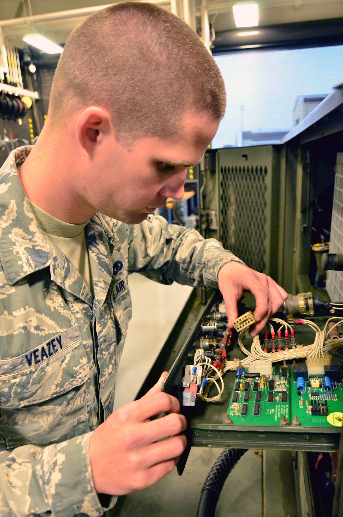 Staff Sgt. Kenneth Veazey, a maintainer with the 403rd Aerospace Ground Equipment Flight on Keesler Air Force Base, checks a protective relay drawer on an A/M 32A-86 "dash 86" generator during a water pump repair. (U.S. Air Force photo by/Master Sgt. Brian Lamar)