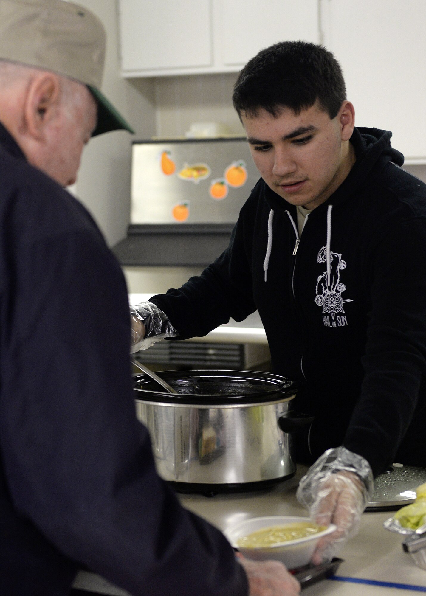 ALTUS AIR FORCE BASE, Okla. – U.S. Air Force Senior Airman Josenan Cruz, 97th Medical Group Tricare operations and patient administration clerk, serves a bowl of soup at the Salvation Army Soup Kitchen, Jan. 8, 2015. Over the course of four hours, Cruz and five other Airmen helped serve sandwiches, soup and dessert to more than 50 individuals in need. (U.S. Air Force photo by Senior Airman Levin Boland/Released)