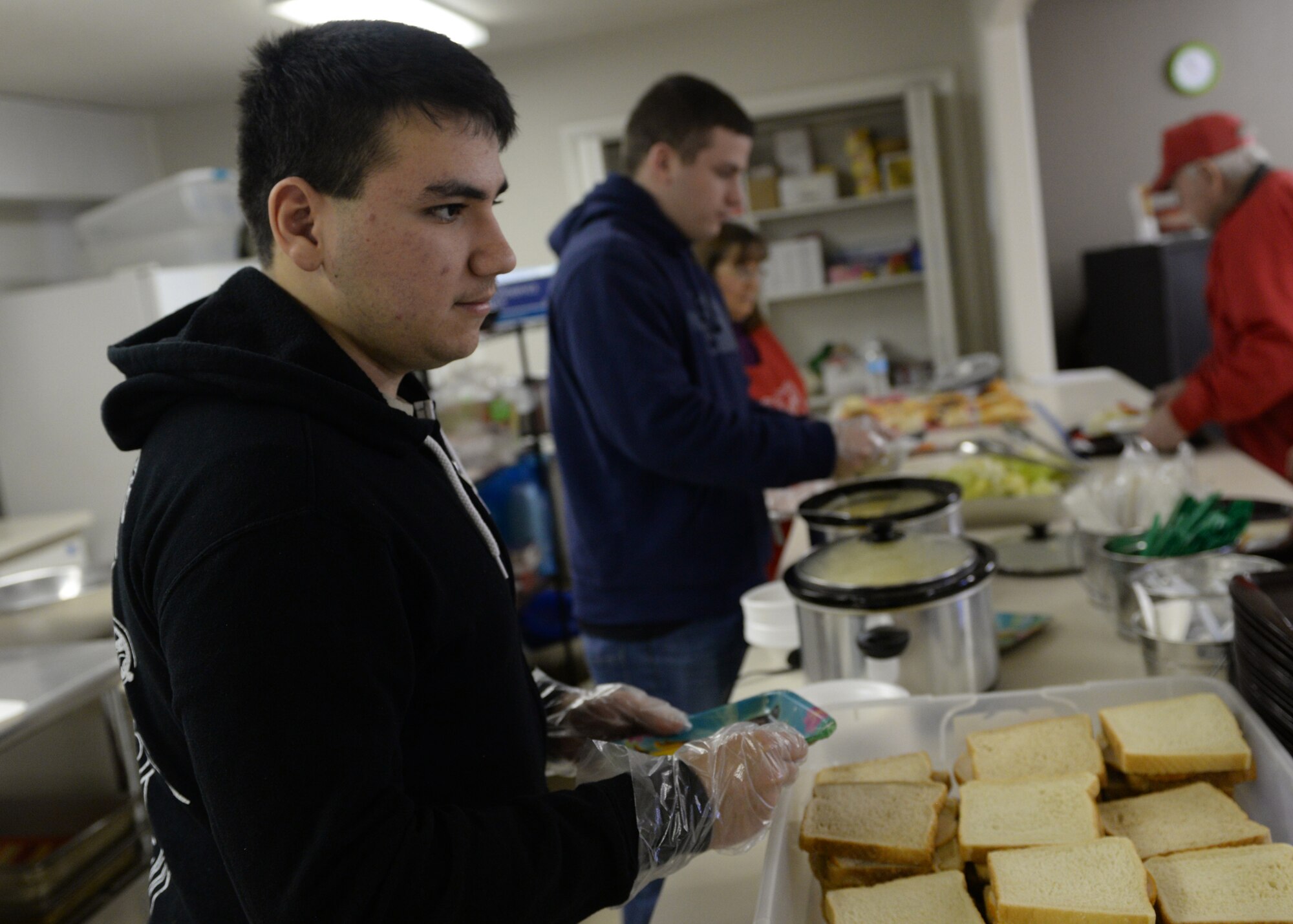 ALTUS AIR FORCE BASE, Okla. – U.S. Air Force Senior Airman Josenan Cruz, 97th Medical Group Tricare operations and patient administration clerk, prepares sandwiches at the Salvation Army Soup Kitchen, Jan. 8, 2015. Cruz and five other Airmen spent four hours preparing and serving plates of food to community members in need. (U.S. Air Force photo by Senior Airman Levin Boland/Released)