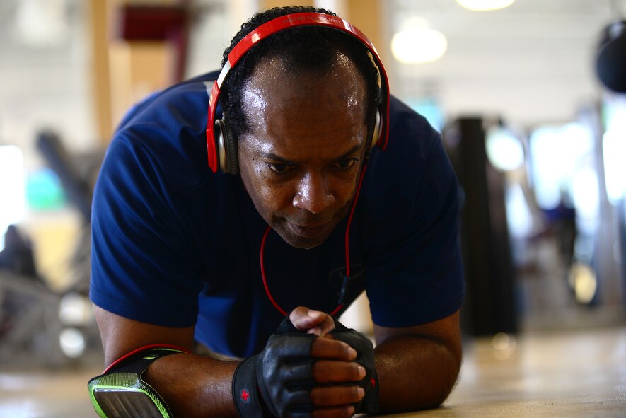 Retired U.S. Air Force Chief Master Sgt. Joe Romeo does a plank during his daily workout at Shaw Air Force Base, S.C, Jan. 9, 2015. Romeo retired out of Langley Air Force Base, Va., after 30 years of service, initially enlisting as a services specialist. (U.S. Air Force photo by Airman 1st Class Michael Cossaboom/Released)