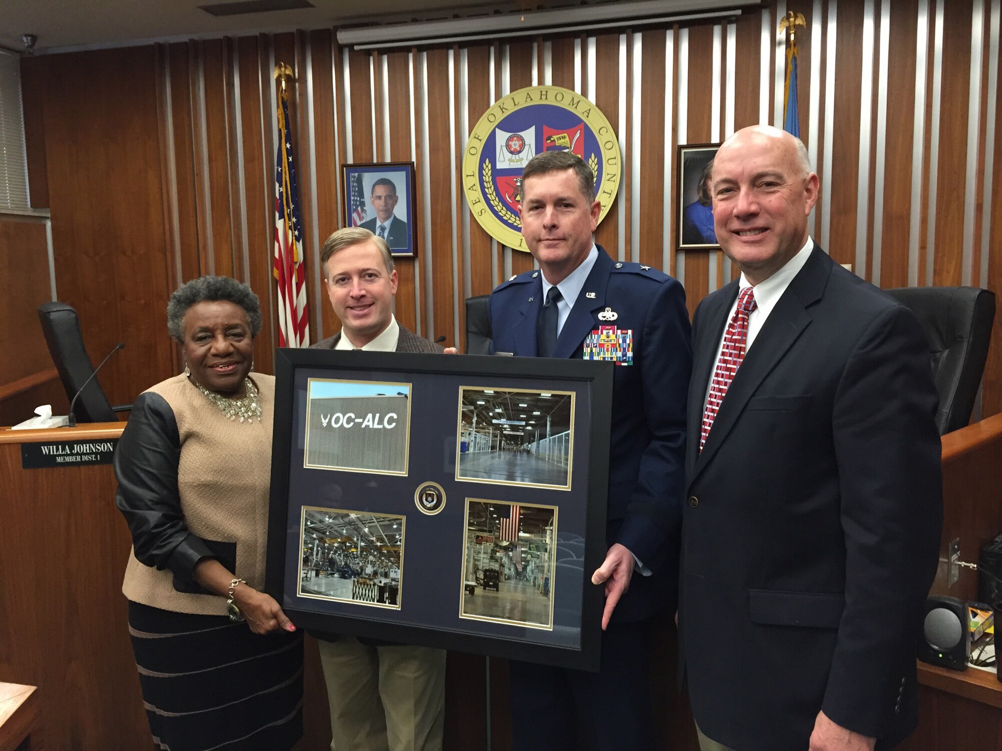 Brig. Gen. Gene Kirkland, commander of the Oklahoma City Air Logistics Complex, made a presentation at the Oklahoma County Commission’s Dec. 31 session. Tinker leadership from OC-ALC and 72nd Air Base Wing were on hand to witness the commission’s vote to transfer Tinker’s Bldg. 9001 and associated facilities to the Air Force. The former General Motors plant was acquired by Oklahoma County in 2008 and has been leased by Tinker AFB since then. The OC-ALC has already transformed more than 75 percent of Bldg. 9001’s 2.5 million square feet into a world-class aerospace facility which houses 1,700 employees performing software, propulsion and commodities maintenance.  Pictured with General Kirkland are, from left, Commissioners Willa Johnson, Brian Maughan and Ray Vaughn. (Courtesy photo)