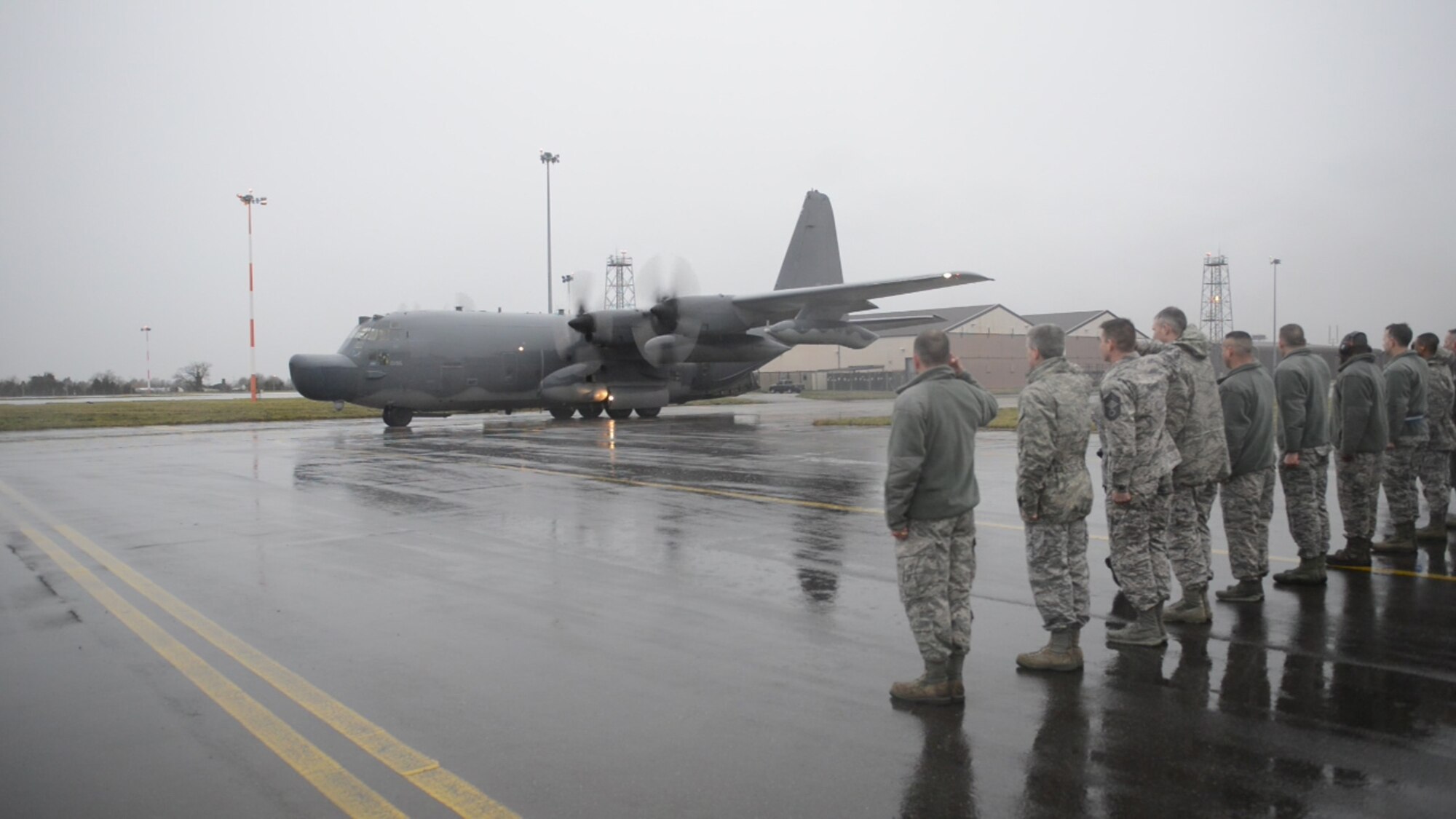 Airmen from the 352nd Special Operations Group and the 100th Air Refueling Wing line Delta Row taxiway Jan. 8, 2015, to render a final salute as the MC-130H Combat Talon II departs RAF Mildenhall for Hurlburt Field, Florida. This departure flight concludes its tenure at the 7th Special Operations Squadron at RAF Mildenhall. The MC-130H, tail number 0195, is the last of its kind to leave the European theater. (U.S. Air Force photo by Senior Airman Laura Yahemiak/Released)