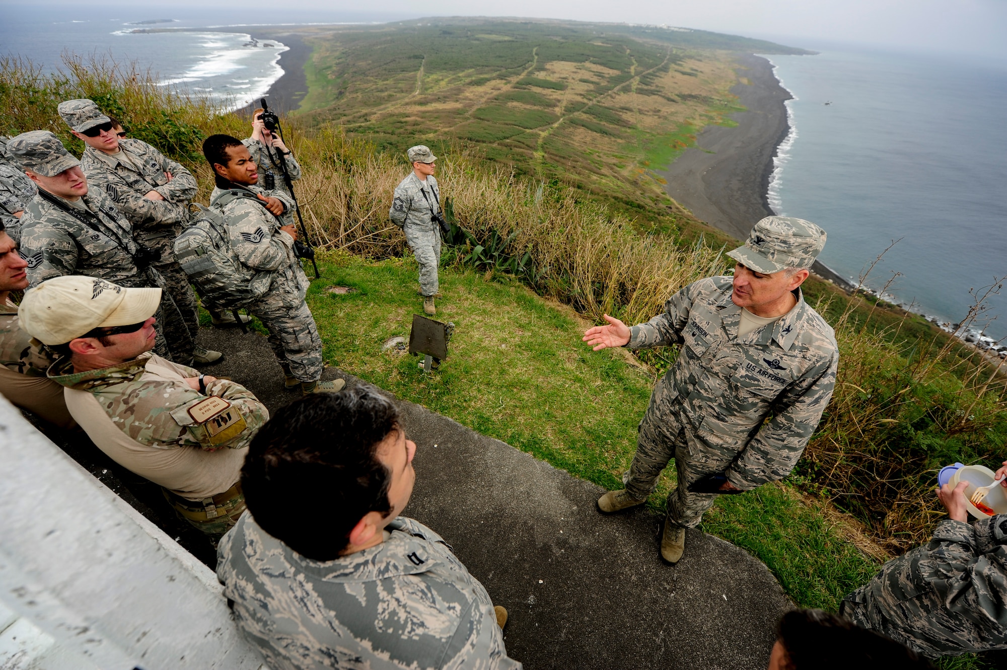 U.S Air Force Col. Paul Johnson, 18th Operations Group commander, delivers a history lesson on top of Mount Suribachi, Jan. 8, 2015, on Iwo To, Japan. He led a group of 32 Airmen from Kadena Air Base, Japan, on a tour through the Island, stopping at various historic sites to educate and pay respect to the U.S. Marines who lost their lives at the battle of Iwo Jima. (U.S. Air Force photo by Airman 1st Class John Linzmeier)