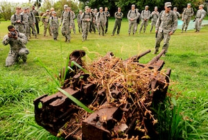 Airmen from Kadena Air Base, Japan, gather around a rusted Type 96 Imperial Japanese Navy 25mm dual-purpose anti-tank/anti-aircraft gun Jan. 8, 2015, on Iwo To, Japan. The island was previously known as Iwo Jima and was the battleground of the largest assault in U.S. Marine Corps history, lasting 36 days and having more than 26,000 Japanese and American casualties. The Airmen traveled on an aircraft conducting a training mission with Iwo To enroute. (U.S. Air Force photo by Airman 1st Class John Linzmeier)