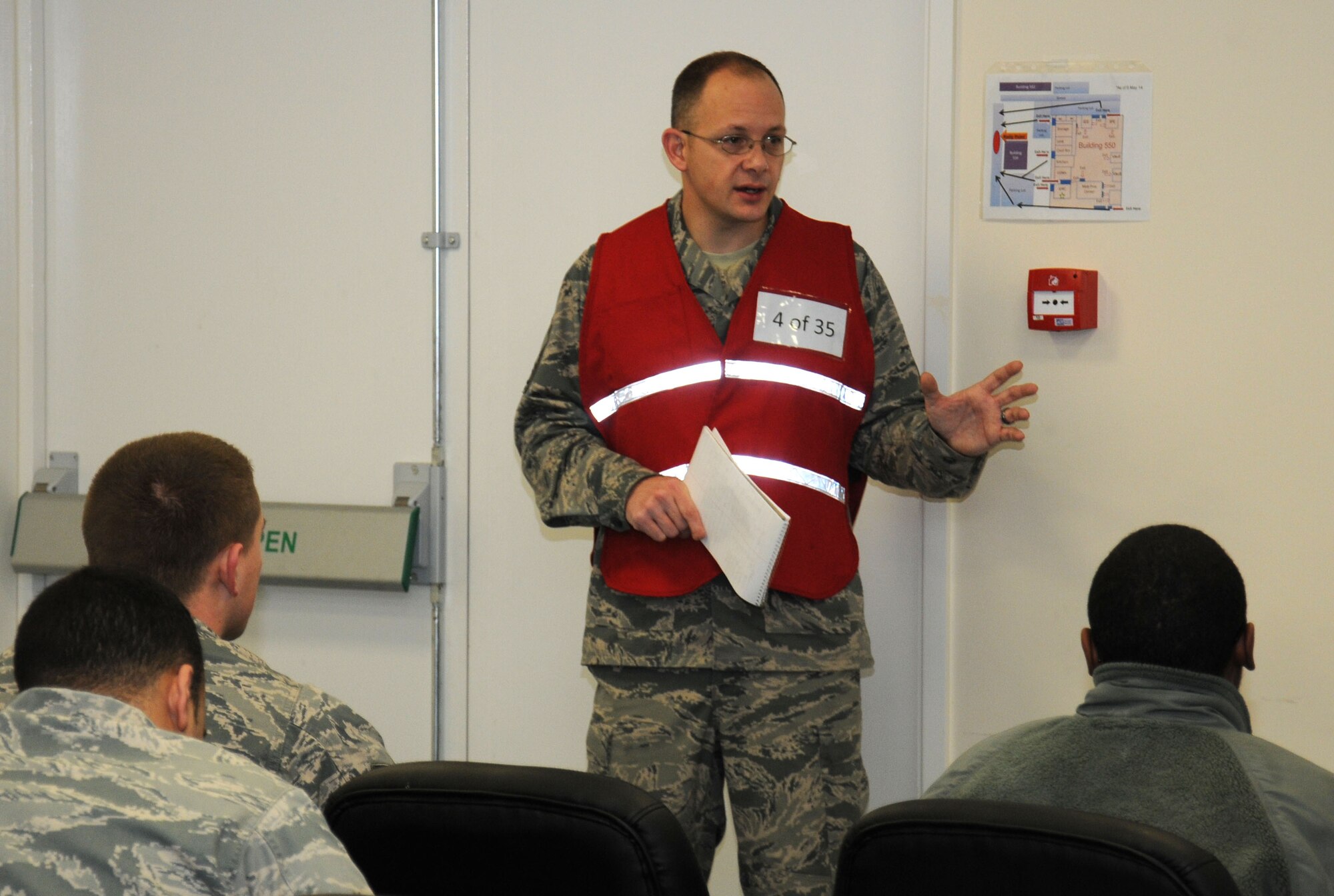 U.S. Air Force Senior Master Sgt. Andrew Gilbert, 100th Logistics Readiness Squadron Installation Deployment Readiness Cell superintendent from Columbia, Mo., wraps up chalk processing by discussing readiness Jan. 7, 2015, on RAF Mildenhall, England. Gilbert wanted to get an understanding of the group’s preparedness and concerns if they were going to actually depart on a short-notice deployment. This was in an effort to ensure personnel deployment function processing lines are providing what deployers need prior to departure. (U.S. Air Force photo by Gina Randall/Released)
