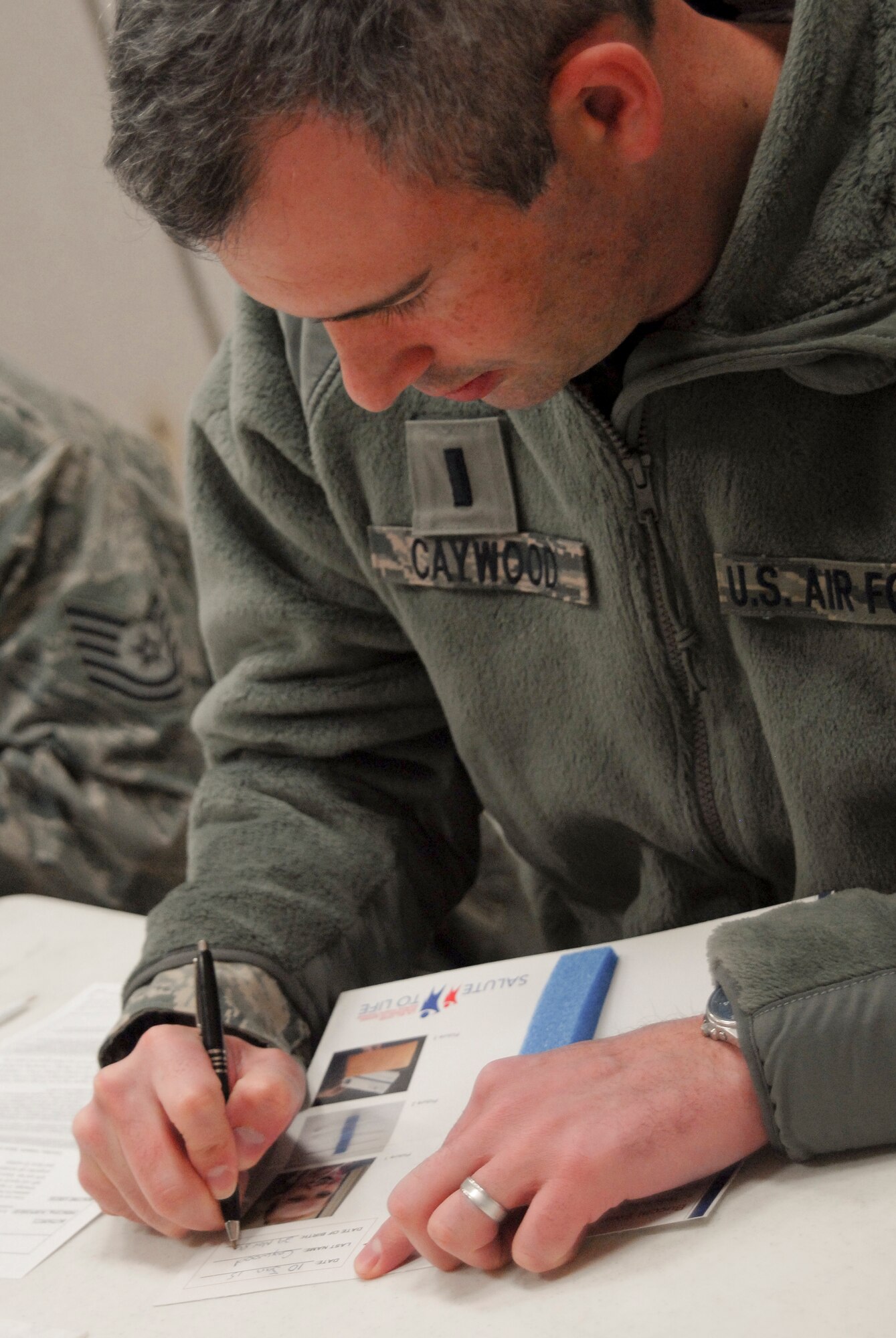 U.S. Air Force Chaplain, 1st Lt. Robert Caywood, a chaplain with the 180th Fighter Wing, filled out a consent form during the wing's two-day bone marrow registration drive Jan. 10 2015, part of the Salute to Life Program. The Salute to Life Program, also known as the C.W. Bill Young/Department of Defense Marrow Donor Program, works with active duty and their dependents, guard, reservist and Department of Defense civilian employees to facilitate marrow and stem cell donations. All of the donors are volunteers and since the program inception in 1991, more than 750,000 individuals to fight against blood cancer and other fatal diseases.  Air National Guard photo by Senior Master Sgt. Beth Holliker (Released)
