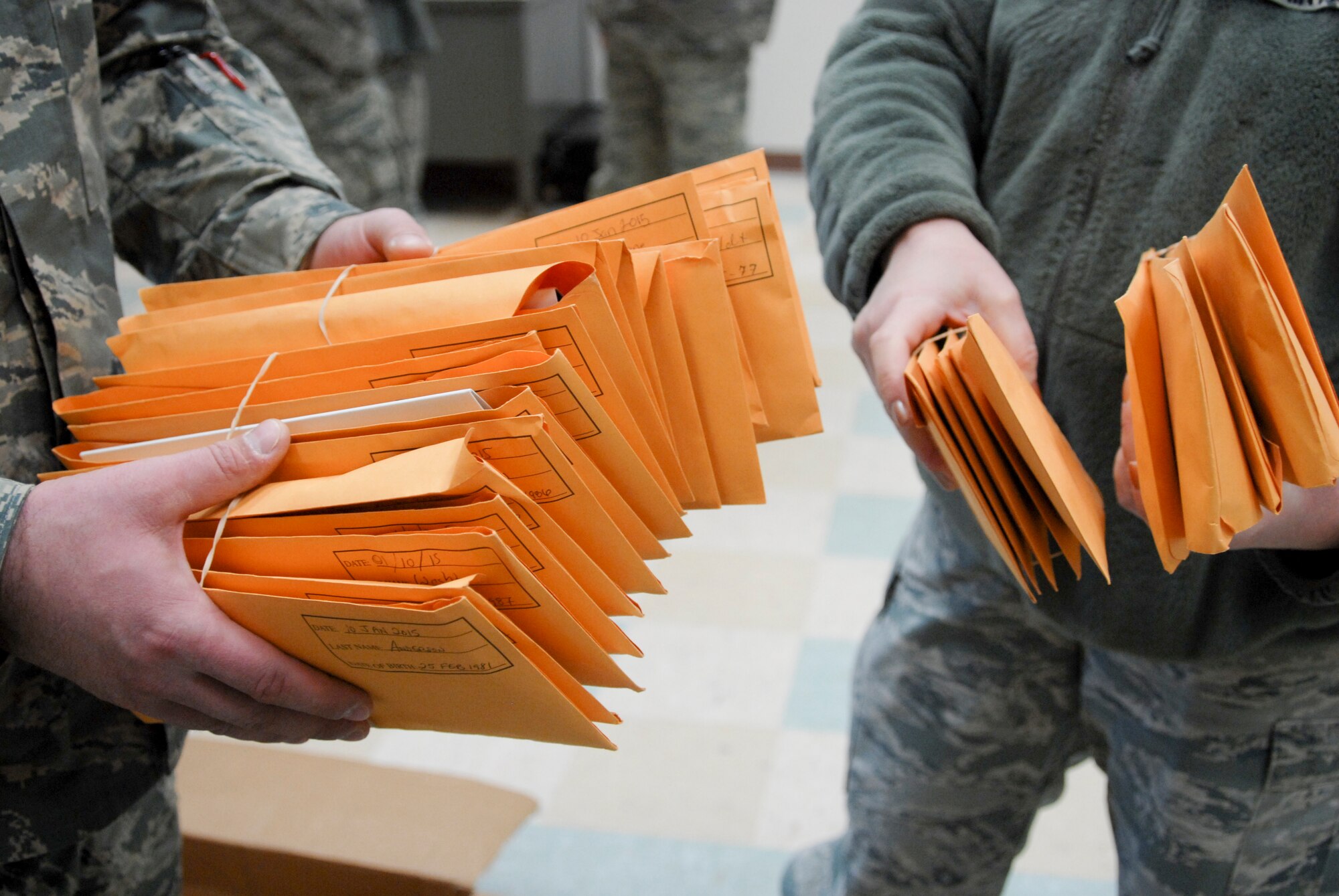 U.S. Air Force Airmen from the 180th Fighter Wing prepare over 30-plus registration packages to send to Salute to Life Program to join the national registry of volunteer bone marrow donors during the wing's two-day bone marrow registration drive Jan. 10 2015. The Airmen volunteered to complete consent forms and a swab of the inside of their cheek as part of the Salute to Life Program. The Salute to Life Program, also known as the C.W. Bill Young/Department of Defense Marrow Donor Program, works with active duty and their dependents, guard, reservist and Department of Defense civilian employees to facilitate marrow and stem cell donations. All of the donors are volunteers and since the program inception in 1991, more than 750,000 individuals to fight against blood cancer and other fatal diseases.  Air National Guard photo by Senior Master Sgt. Beth Holliker (Released)