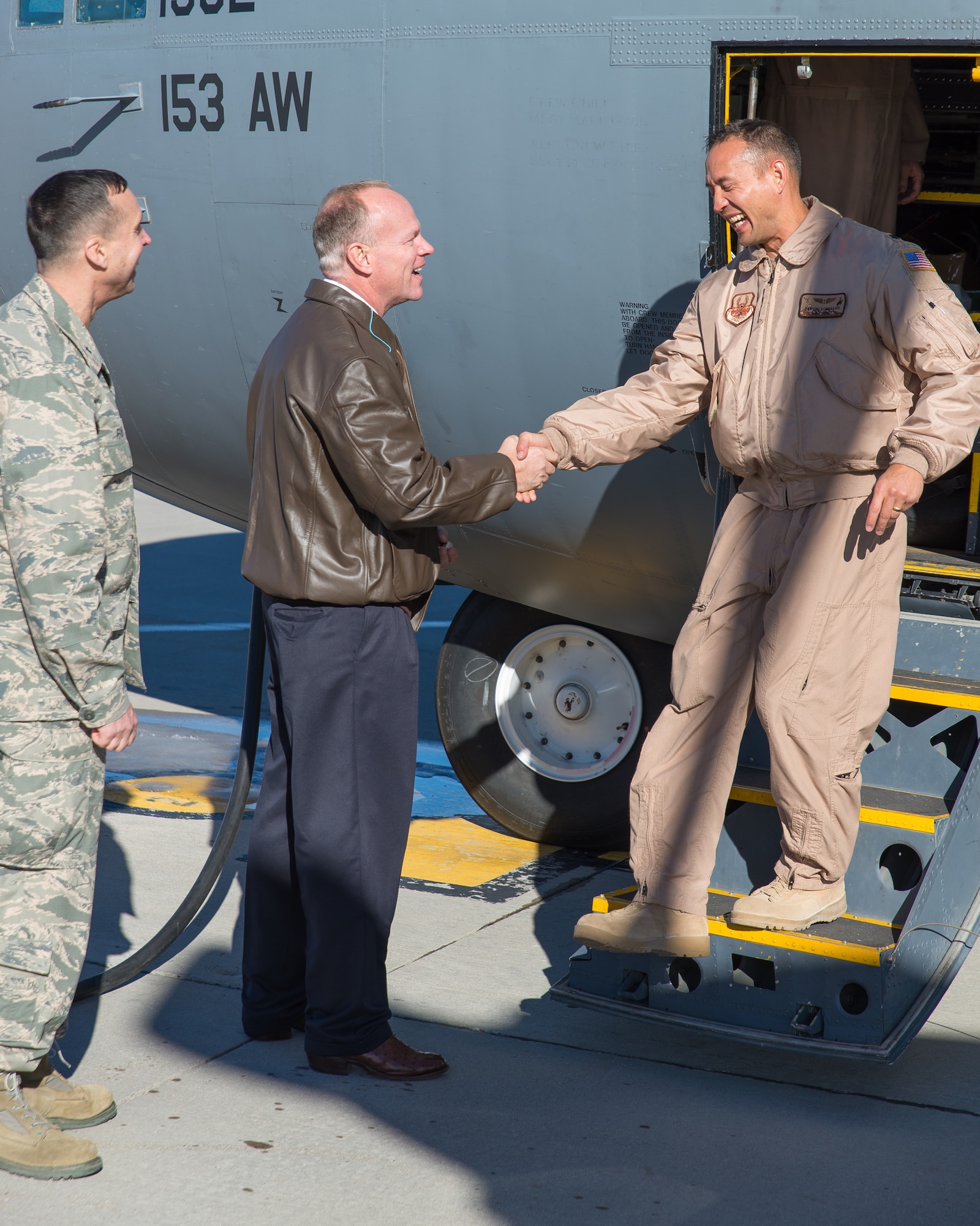 Wyoming Governor Matt Mead and Wyoming Air National Guard Chief of Staff Brig. Gen. Stephen Rader welcome Lt. Col. Dayton Kobayashi home Jan. 8, 2015 at Cheyenne Air National Guard Base in Cheyenne, Wyoming. Around 60 members of the 153rd Airlift Wing, Wyoming Air National Guard, returned home this week following a two-month deployment to Southwest Asia.