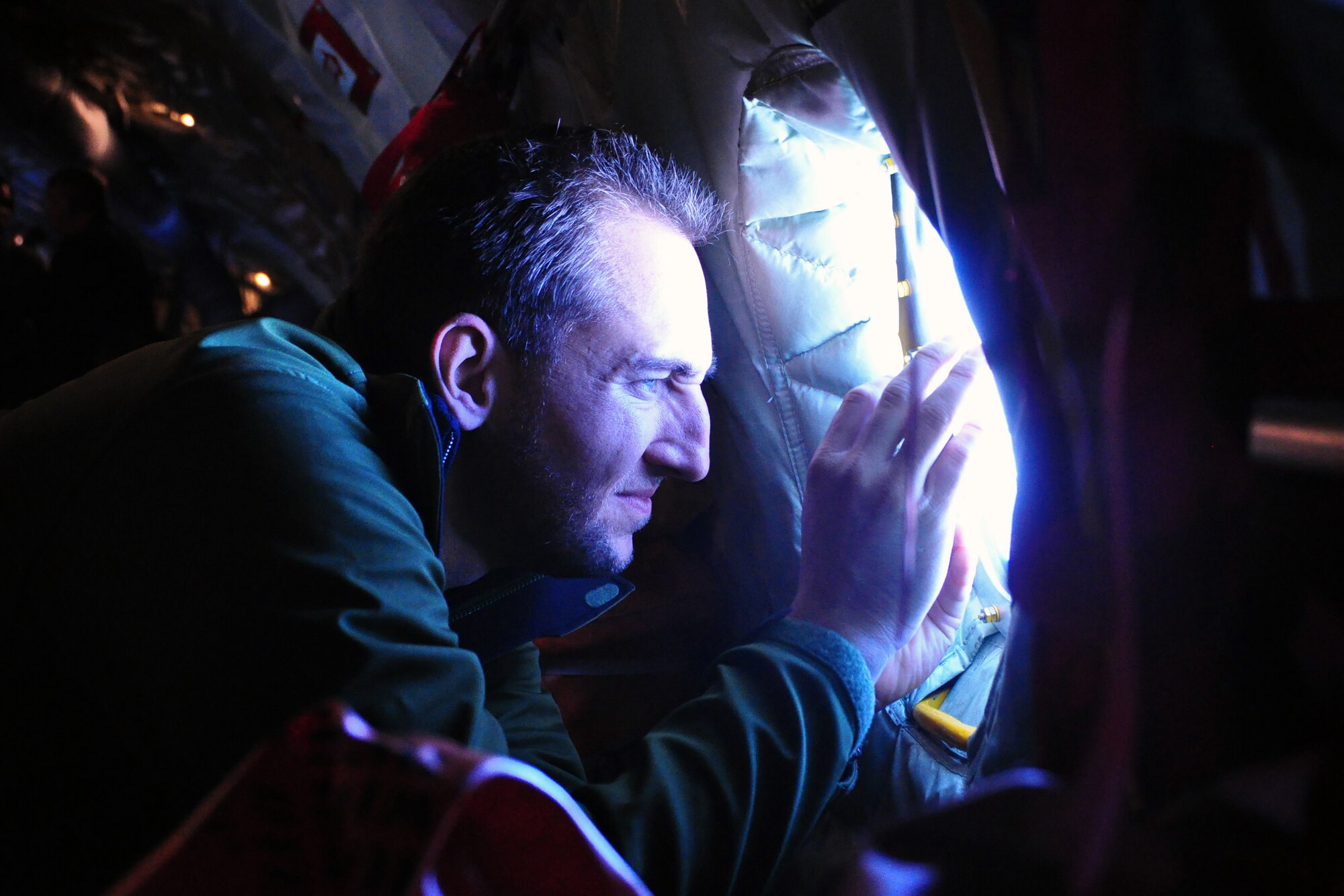 Aaron Rickelman, employer flight guest, takes a photo while looking out the window of a KC-135R Stratotanker during a 916th Air Refueling Wing "bosslift." Dec. 6, 2014. The event was sponsored by the Employer Support of the Guard and Reserve and is designed to facilitate a good relationship between the wing and those who employ traditional Reservists. (U.S. Air Force photo by Master Sgt. Wendy Lopedote)