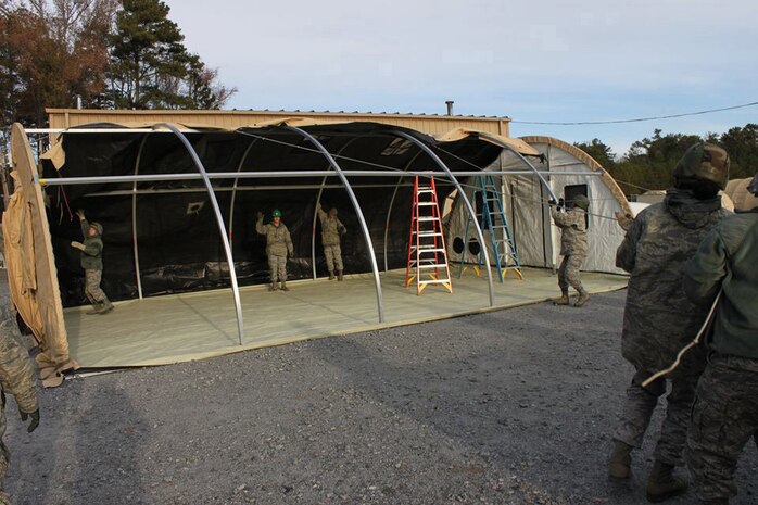 Dobbins Air Reserve Base, Ga. – Airmen of the 166th Force Support Squadron from the Delaware Air National Guard erect a TEMPER (or Tent, Extendable, Modular, Personnel) shelter tent on Nov. 19 during combat training conducted here Nov. 14-21, 2014. (U.S. Air National Guard photo by Staff Sgt. Brian Ford)
