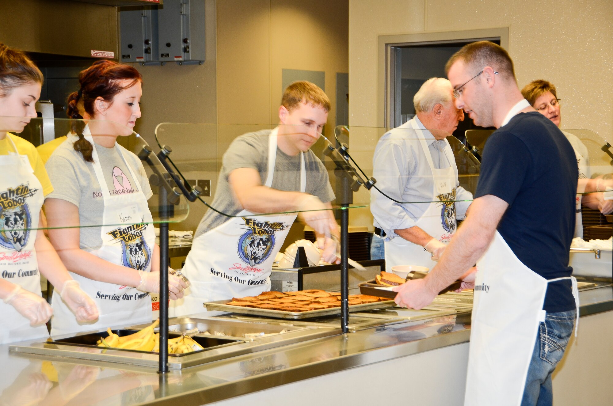 SIOUX FALLS, S.D. - Members of the Rising Six organization serve a meal at the Banquet as part of the groups community outreach program.  On that evening they served 279 meals which included 30 meals to children.(National Guard photo by Senior Master Sgt. Nancy Ausland/Released)