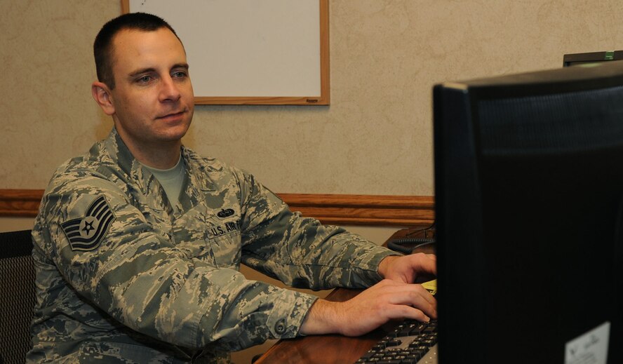 Tech. Sgt. Brett Merchant, 2nd Communications Squadron client service center supervisor, works in his office on Barksdale Air Force Base, La. Jan. 6, 2015. Tech. Sgt. Merchant was promoted through the Stripes for Exceptional Performers program which recognizes Airmen who are role models to their peers, demonstrate leadership, comprehension and above-and-beyond dedication to the mission. (U.S. Air Force photo/Senior Airman Kristin High)