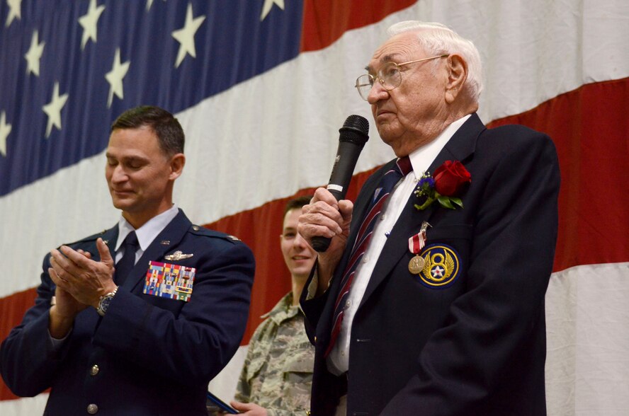 William B. Hughey, a WWII veteran speaks to Reservists after being presented with the Army Good Conduct Medal by Col. Brett Clark, 94th Airlift Wing, commander at a Wing commanders call on Dobbins Air Reserve Base, Ga. Jan. 10, 2015. Hughey served in the U.S. Army Air Corps as a ball turret gunner in the 487th Bomb Group, aboard the Boeing B17 in 1944. He successfully completed 35 combat flying missions. (U.S. Air Force photo/Don Peek)